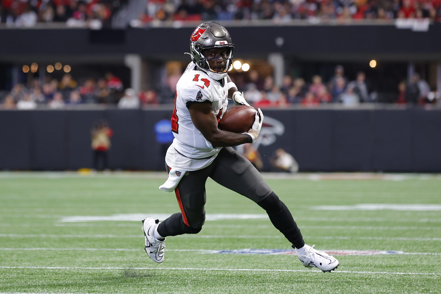 ATLANTA, GA - JANUARY 08: Chris Godwin #14 of the Tampa Bay Buccaneers makes a reception and turns upfield during the first half against the Atlanta Falcons at Mercedes-Benz Stadium on January 8, 2023 in Atlanta, Georgia. (Photo by Todd Kirkland/Getty Images)