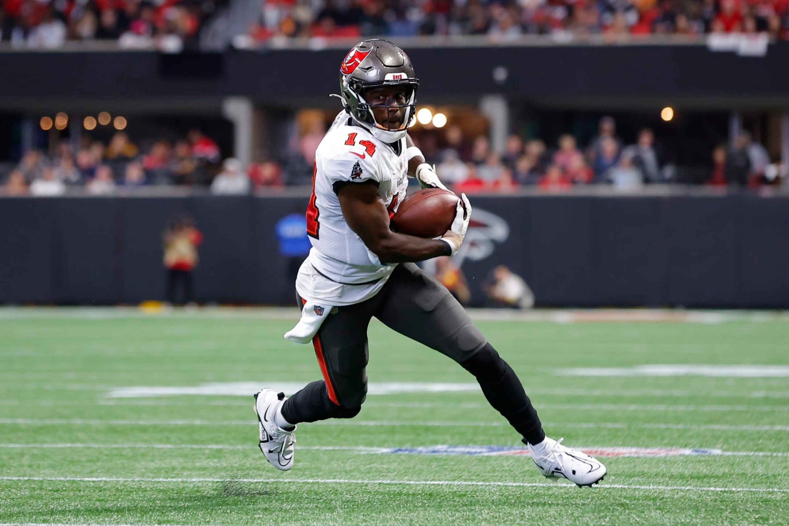 ATLANTA, GA - JANUARY 08: Chris Godwin #14 of the Tampa Bay Buccaneers makes a reception and turns upfield during the first half against the Atlanta Falcons at Mercedes-Benz Stadium on January 8, 2023 in Atlanta, Georgia. (Photo by Todd Kirkland/Getty Images)