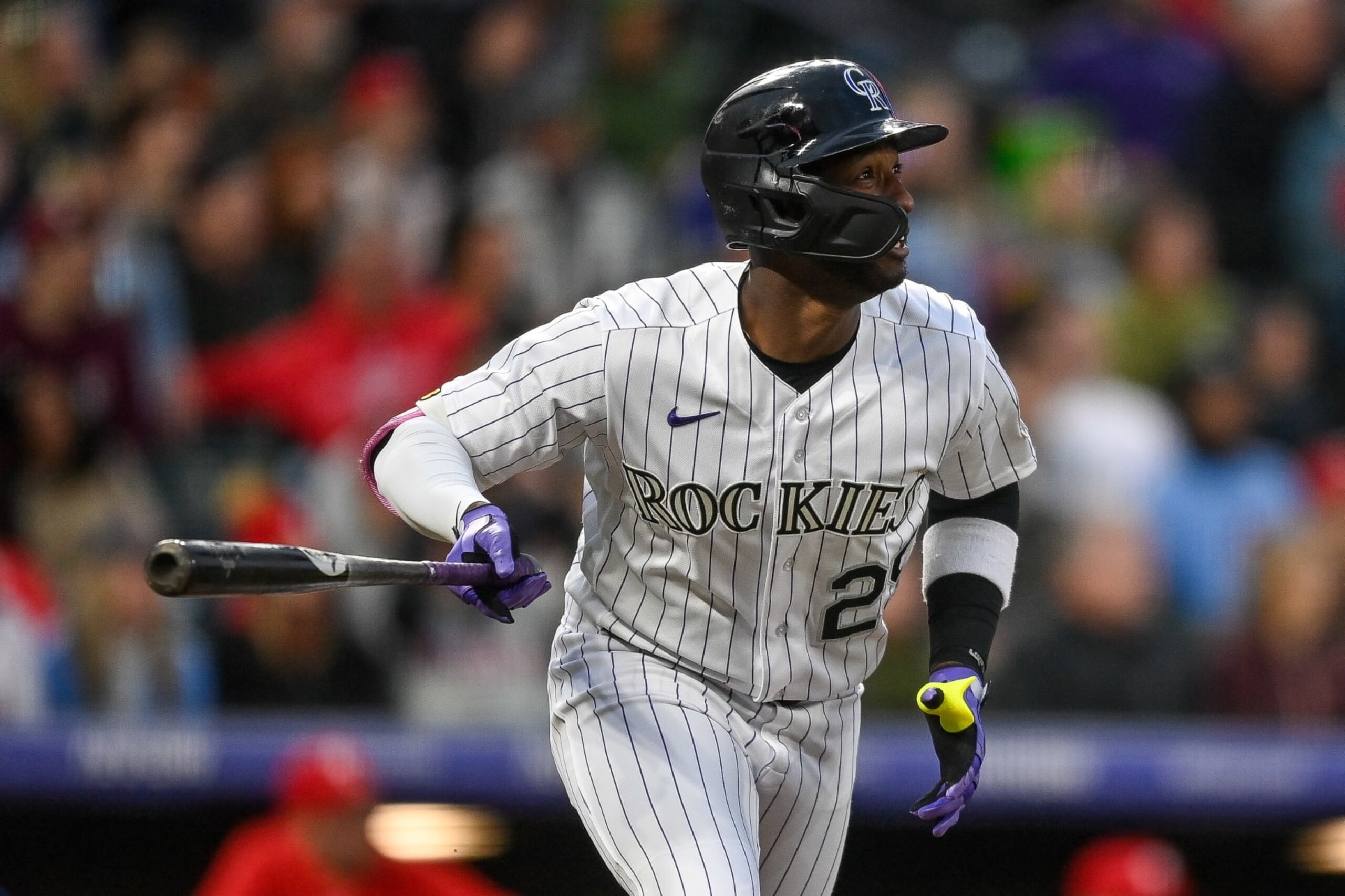 DENVER, CO - MAY 12: Jurickson Profar #29 of the Colorado Rockies hits a sixth inning double against the Philadelphia Phillies in a game at Coors Field on May 12, 2023 in Denver, Colorado. (Photo by Dustin Bradford/Getty Images)
