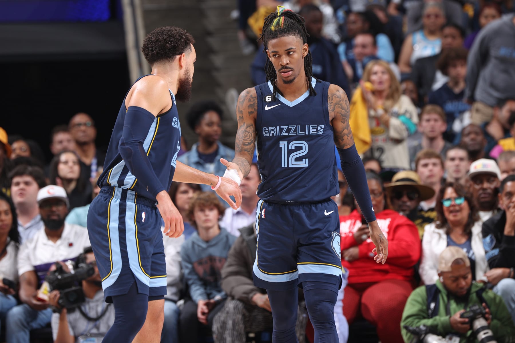 MEMPHIS, TN - APRIL 16: Tyus Jones #21 and Ja Morant #12 of the Memphis Grizzlies shake hands against the Los Angeles Lakers during Round 1 Game 1 of the NBA Playoffs on April 16, 2023 at FedExForum in Memphis, Tennessee. NOTE TO USER: User expressly acknowledges and agrees that, by downloading and or using this photograph, User is consenting to the terms and conditions of the Getty Images License Agreement. Mandatory Copyright Notice: Copyright 2023 NBAE (Photo by Joe Murphy/NBAE via Getty Images)