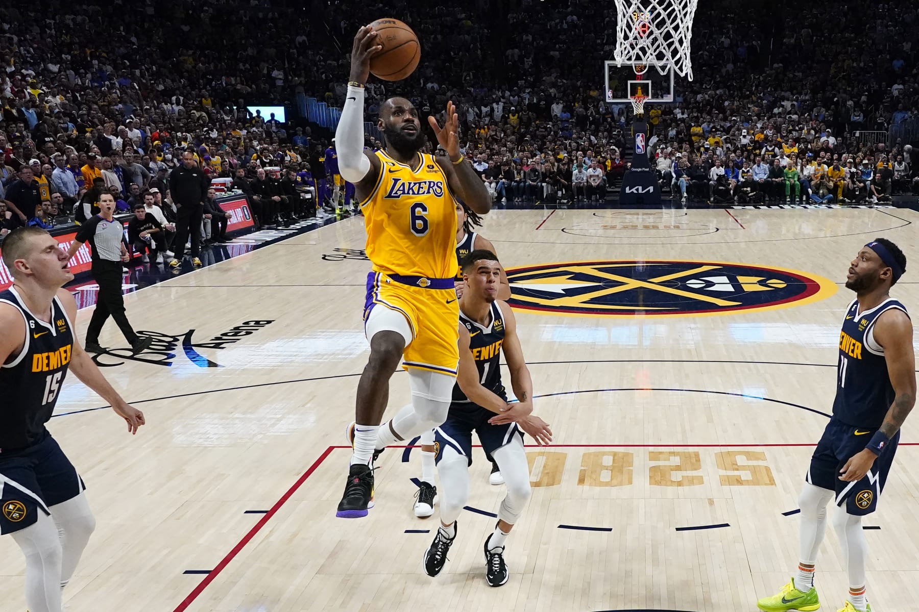 Los Angeles Lakers forward LeBron James (6) drives past Denver Nuggets forward Michael Porter Jr. during the second half of Game 2 of the NBA basketball Western Conference Finals series, Thursday, May 18, 2023, in Denver. (AP Photo/Jack Dempsey)