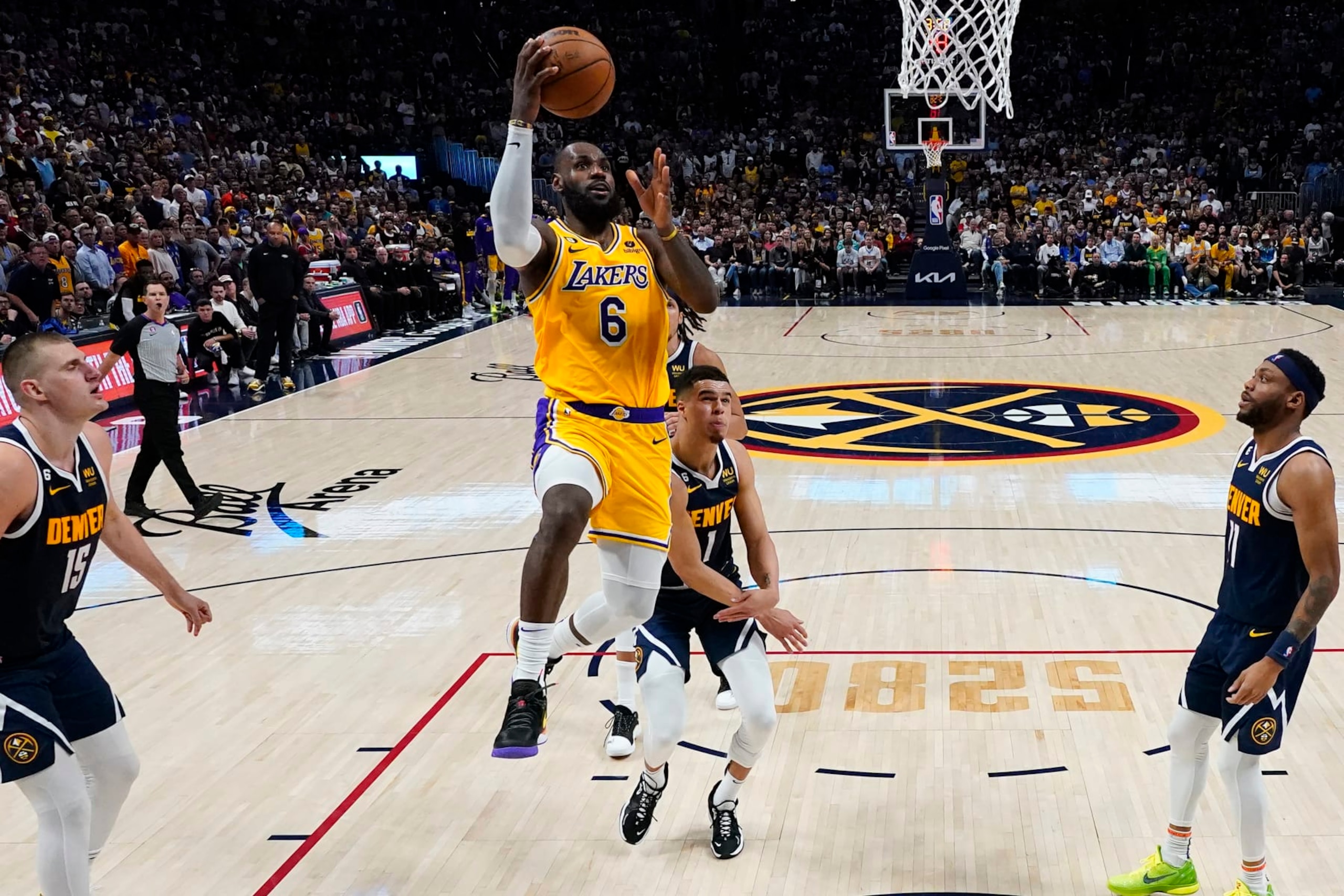 Los Angeles Lakers forward LeBron James (6) drives past Denver Nuggets forward Michael Porter Jr. during the second half of Game 2 of the NBA basketball Western Conference Finals series, Thursday, May 18, 2023, in Denver. (AP Photo/Jack Dempsey)