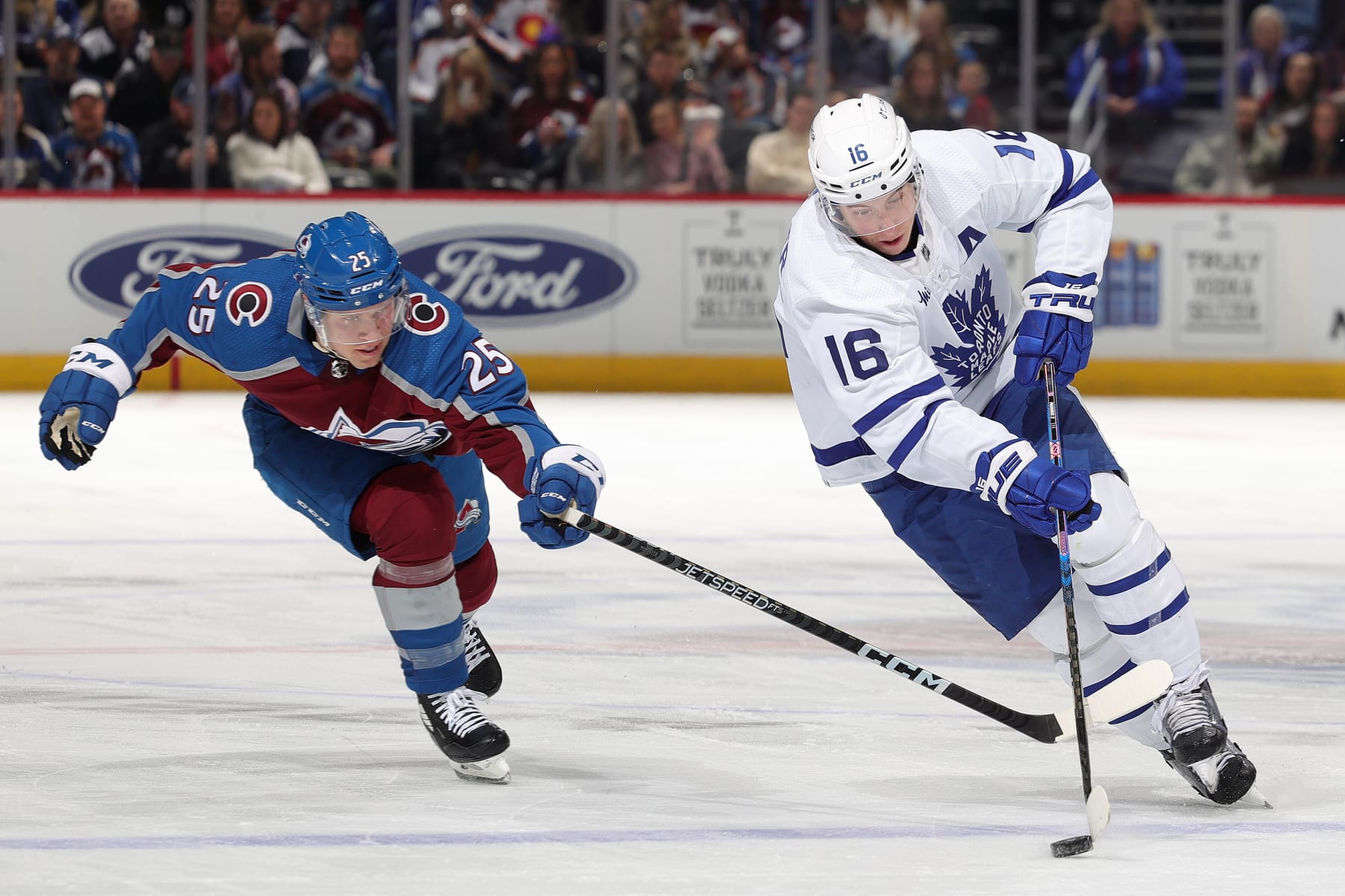 DENVER, COLORADO - DECEMBER 31: Logan O'Connor #25 of the Colorado Avalanche defends against Mitchell Marner #16 of the Toronto Maple Leafs at Ball Arena on December 31, 2022 in Denver, Colorado. (Photo by Michael Martin/NHLI via Getty Images)