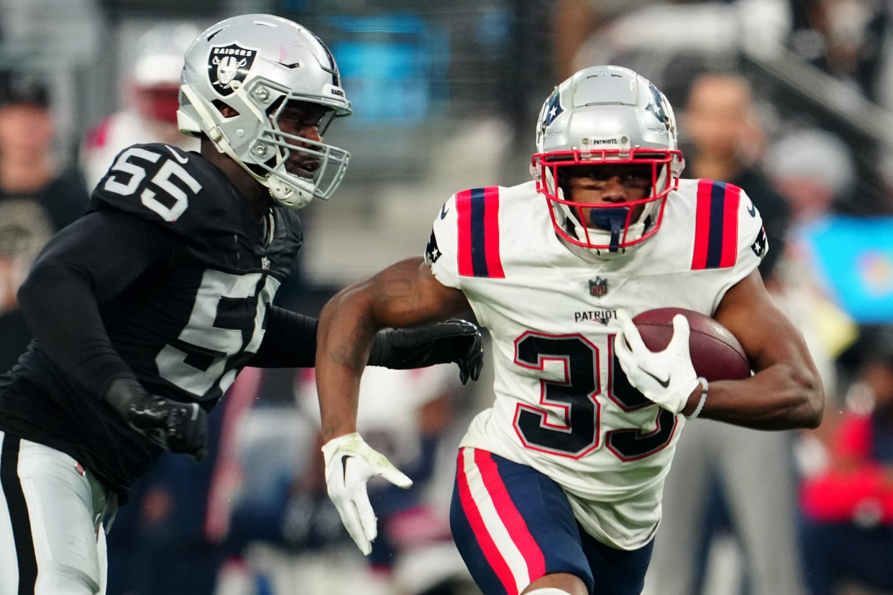 LAS VEGAS, NEVADA - DECEMBER 18: Pierre Strong Jr. #35 of the New England Patriots runs with the ball as Chandler Jones #55 of the Las Vegas Raiders defends during the third quarter at Allegiant Stadium on December 18, 2022 in Las Vegas, Nevada. (Photo by Jeff Bottari/Getty Images)