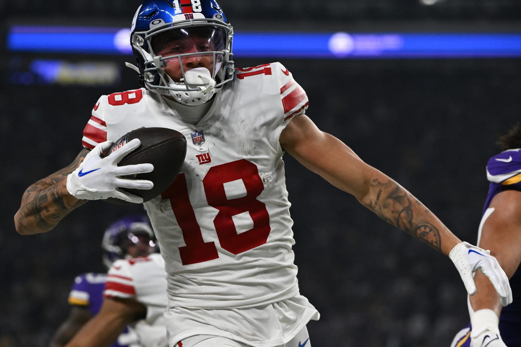 MINNEAPOLIS, MINNESOTA - JANUARY 15: Isaiah Hodgins #18 of the New York Giants runs for a touchdown after catching a pass during the third quarter against the Minnesota Vikings in the NFC Wild Card playoff game at U.S. Bank Stadium on January 15, 2023 in Minneapolis, Minnesota. (Photo by Stephen Maturen/Getty Images)