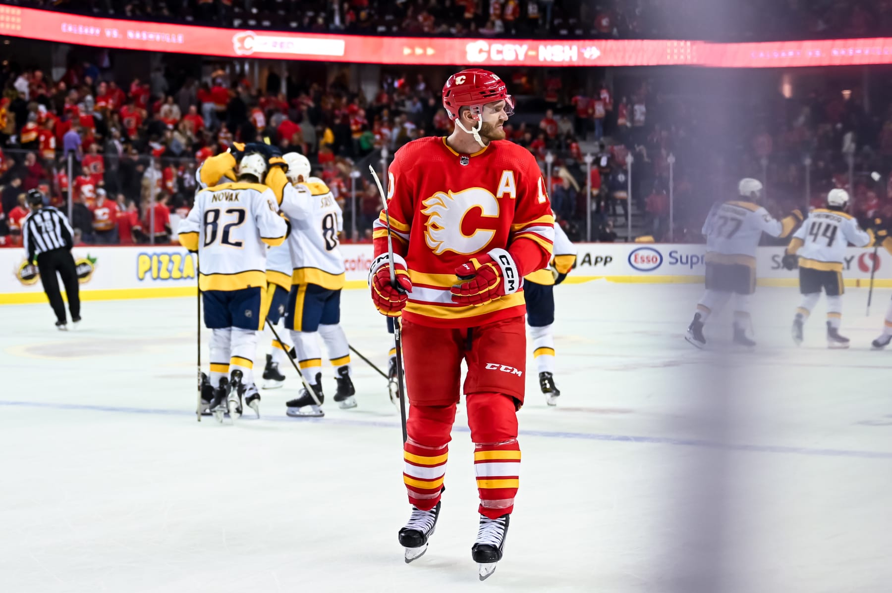 CALGARY, AB - APRIL 10: Calgary Flames Left Wing Jonathan Huberdeau (10) looks on as the Nashville Predators celebrate their 3-2 shootout win after an NHL game on April 10, 2023, at the Scotiabank Saddledome in Calgary, AB. (Photo by Brett Holmes/Icon Sportswire via Getty Images)