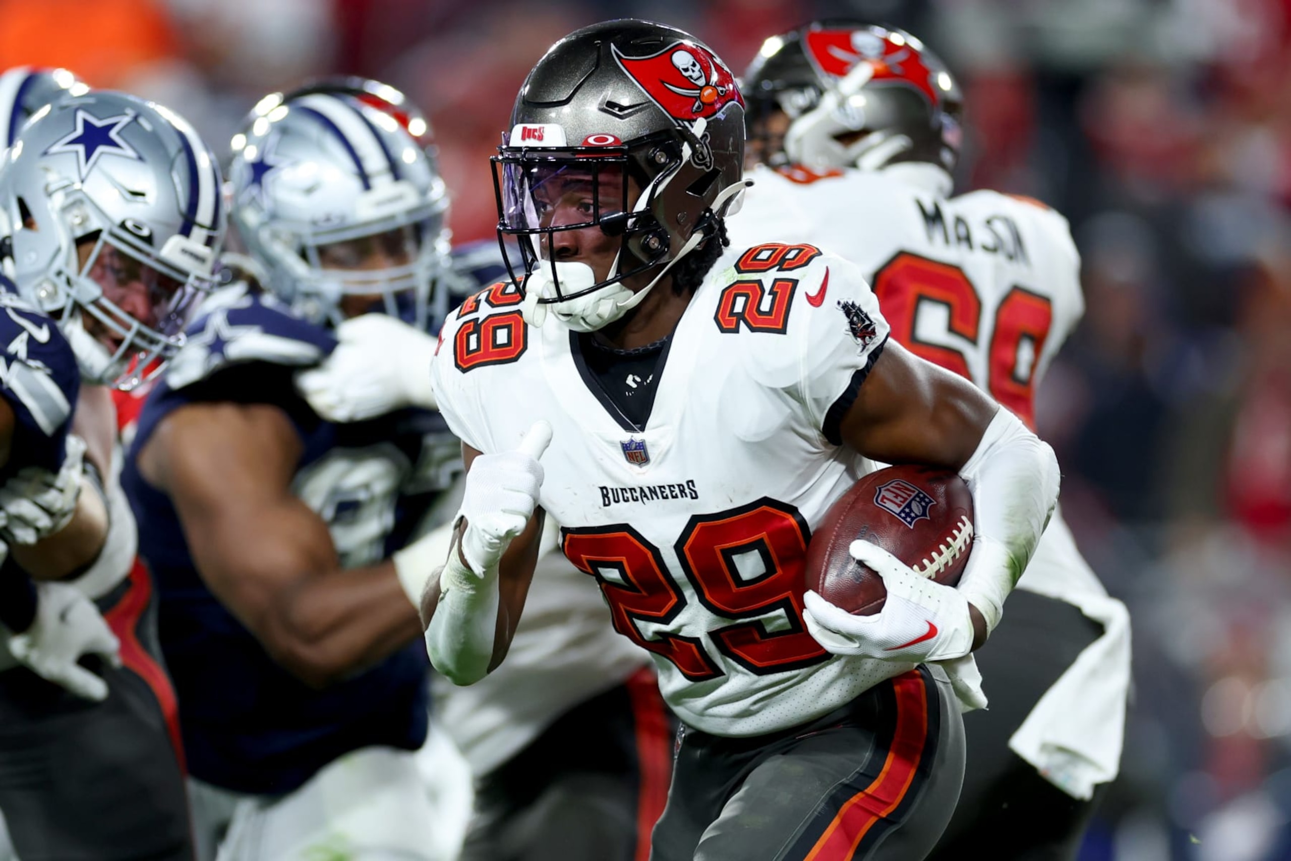 TAMPA, FLORIDA - JANUARY 16: Rachaad White #29 of the Tampa Bay Buccaneers carries the ball against the Dallas Cowboys during the third quarter in the NFC Wild Card playoff game at Raymond James Stadium on January 16, 2023 in Tampa, Florida. (Photo by Mike Ehrmann/Getty Images)