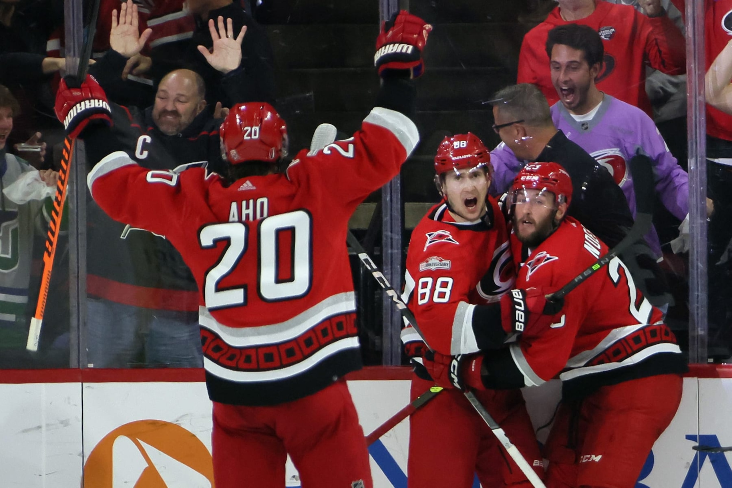 RALEIGH, NORTH CAROLINA - MAY 18: Stefan Noesen #23 of the Carolina Hurricanes celebrates with teammates Martin Necas #88 and Sebastian Aho #20 after scoring a goal on Sergei Bobrovsky #72 of the Florida Panthers during the third period in Game One of the Eastern Conference Final of the 2023 Stanley Cup Playoffs at PNC Arena on May 18, 2023 in Raleigh, North Carolina. (Photo by Bruce Bennett/Getty Images)