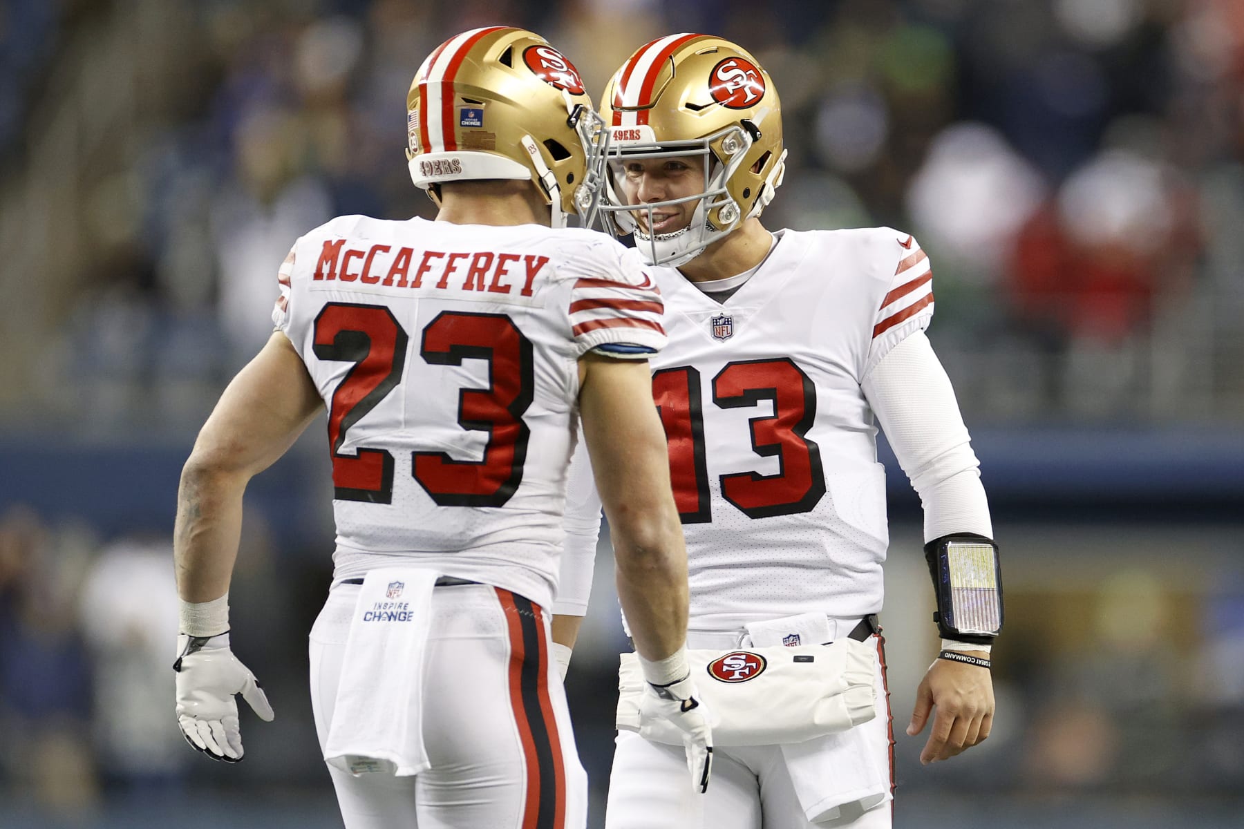 SEATTLE, WASHINGTON - DECEMBER 15: Christian McCaffrey #23 and Brock Purdy #13 of the San Francisco 49ers celebrate a touchdown  during the third quarter against the Seattle Seahawks at Lumen Field on December 15, 2022 in Seattle, Washington. (Photo by Steph Chambers/Getty Images)