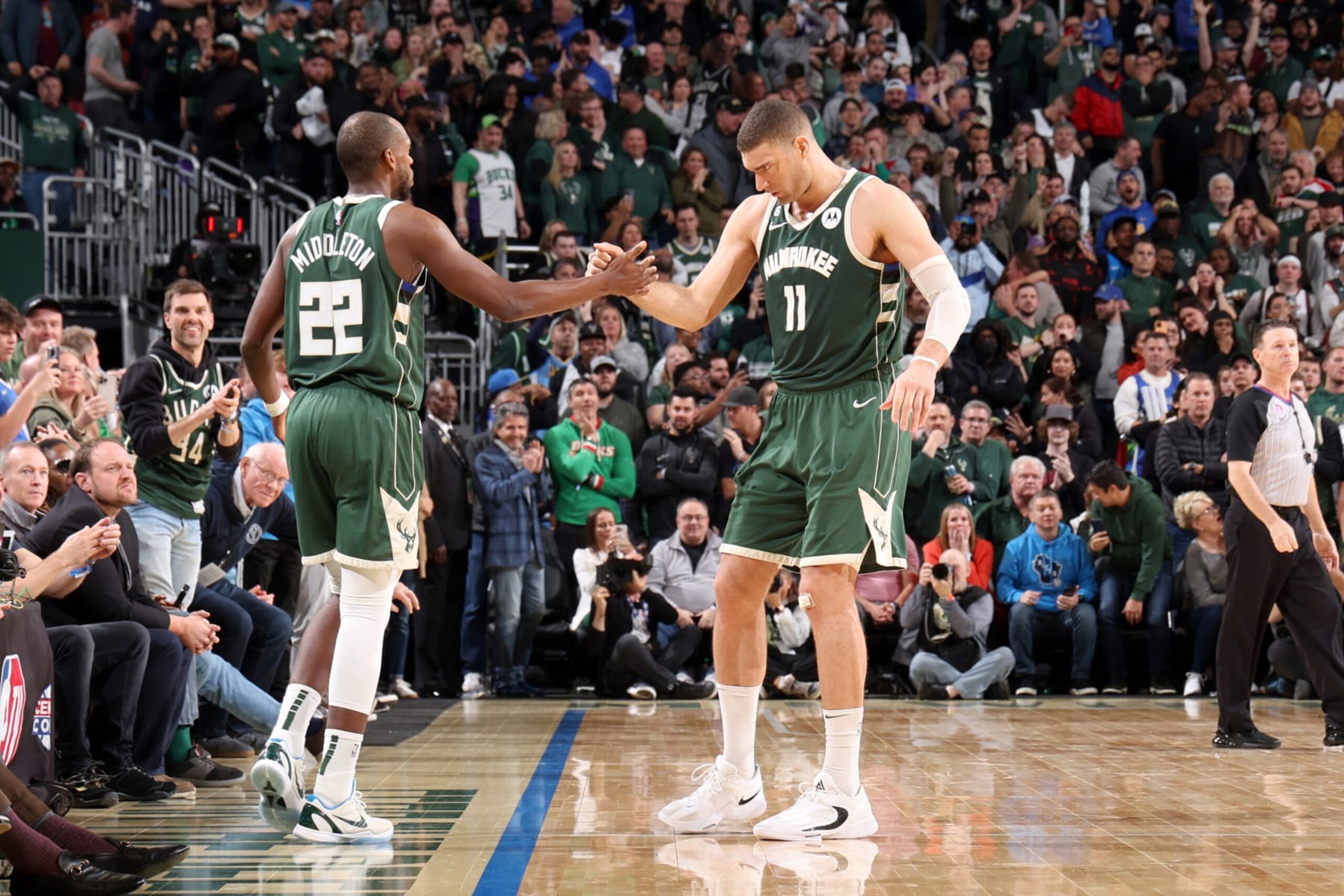 MILWAUKEE, WI - APRIL 26: Khris Middleton #22 of the Milwaukee Bucks high fives Brook Lopez #11 during the game against the Miami Heat during Round 1 Game 5 of the 2023 NBA Playoffs on April 26, 2023 at the Fiserv Forum Center in Milwaukee, Wisconsin. NOTE TO USER: User expressly acknowledges and agrees that, by downloading and or using this Photograph, user is consenting to the terms and conditions of the Getty Images License Agreement. Mandatory Copyright Notice: Copyright 2023 NBAE (Photo by Jeff Haynes/NBAE via Getty Images).