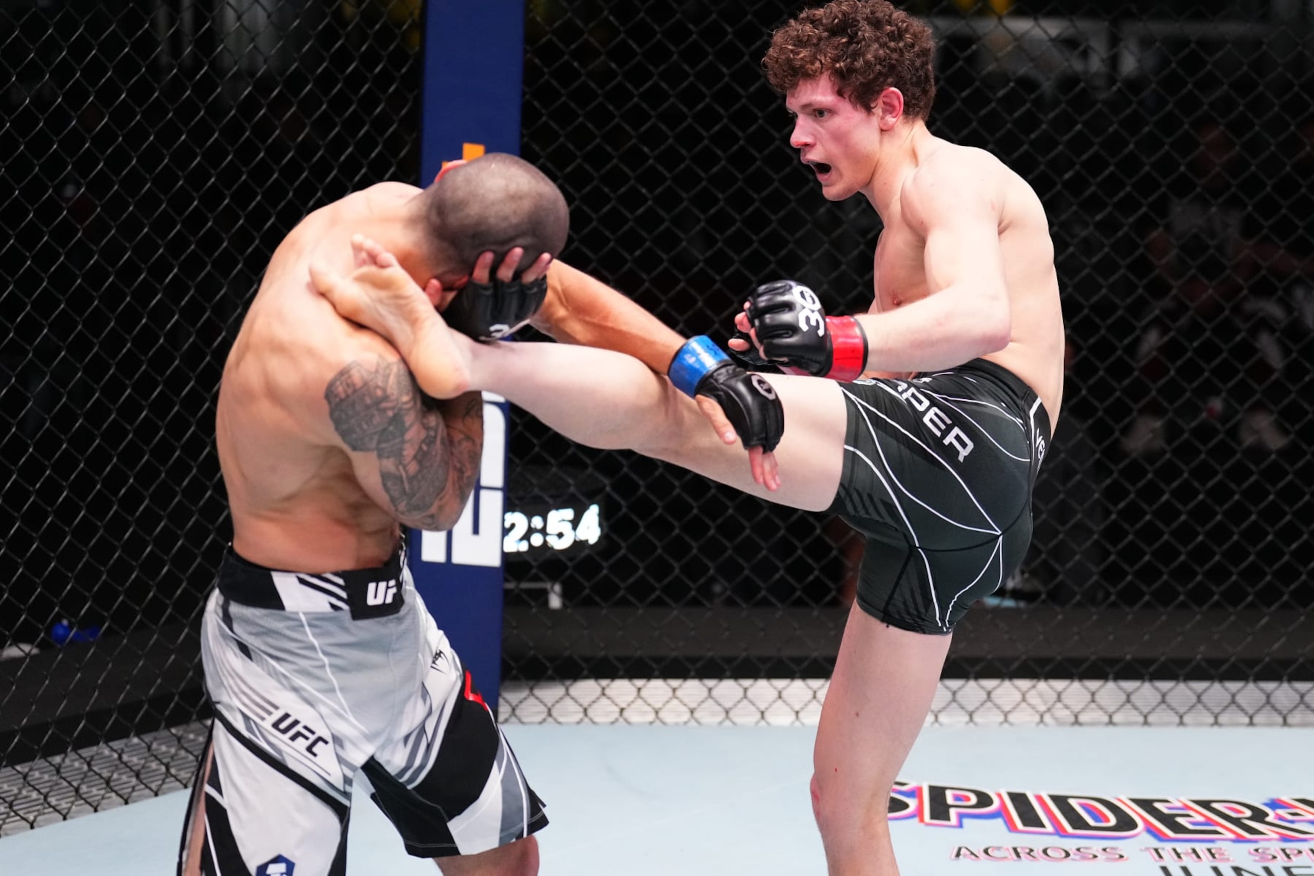 LAS VEGAS, NEVADA - MAY 20: (R-L) Chase Hooper kicks Nick Fiore in a lightweight fight during the UFC Fight Night event at UFC APEX on May 20, 2023 in Las Vegas, Nevada. (Photo by Chris Unger/Zuffa LLC via Getty Images)