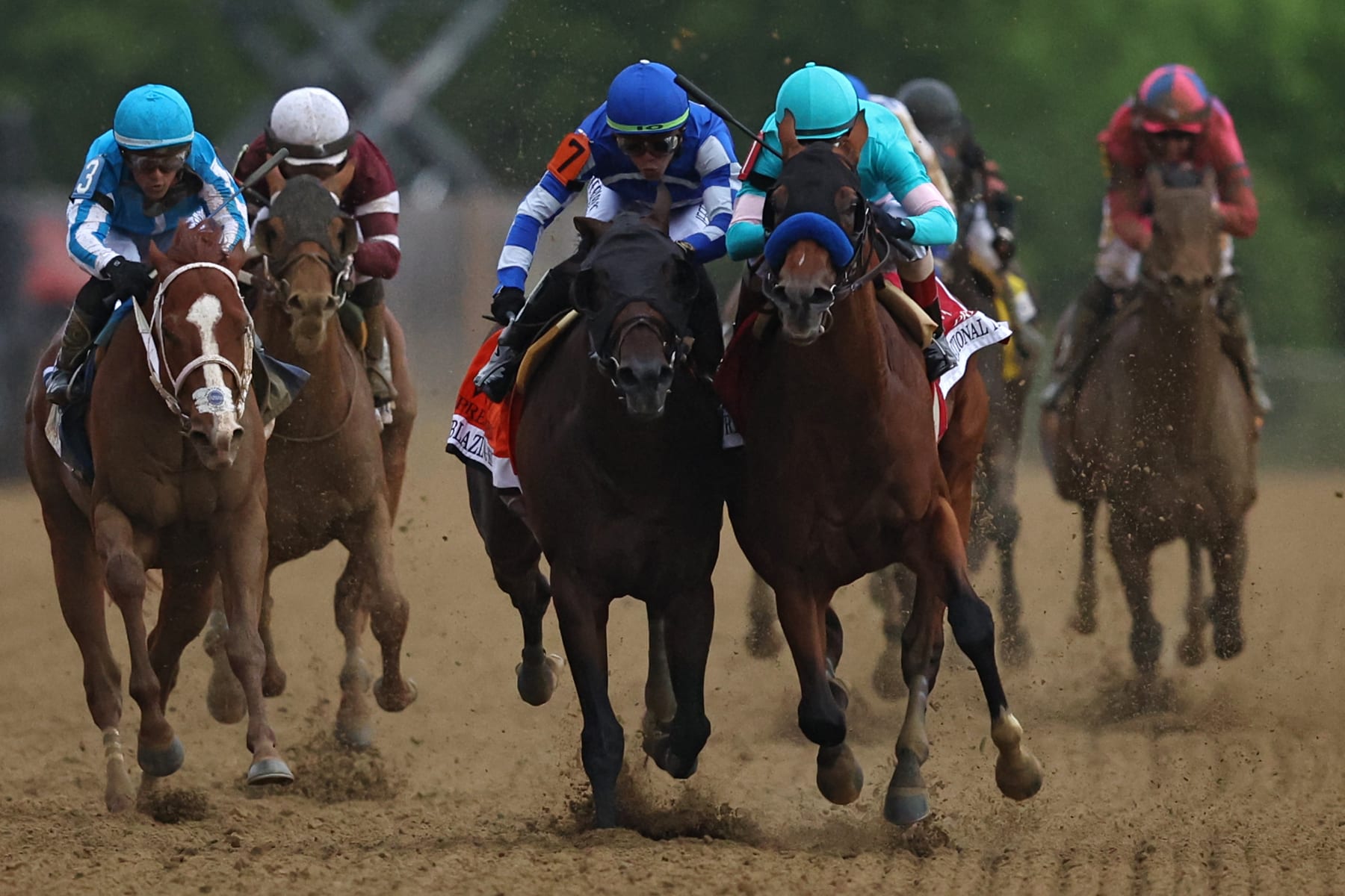 BALTIMORE, MARYLAND - MAY 20: Jockey John Velazquez #1 riding National Treasure (R) rides alongside jockey Irad Ortiz Jr. #7 riding Blazing Sevens (L) to cross the finish line first to win the 148th Running of the Preakness Stakes at Pimlico Race Course on May 20, 2023 in Baltimore, Maryland. (Photo by Patrick Smith/Getty Images)