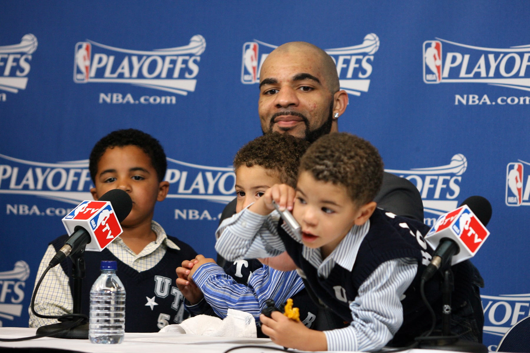 SALT LAKE CITY, UT - APRIL 30:  Carlos Boozer #5 of the Utah Jazz  with three sons Carmani, Cameron and Cayden during post-game interview after defeating the Denver Nuggets 112-104 in Game Six of the Western Conference Quarterfinals during the 2010 NBA Playoffs on April 30, 2010 at the EnergySolutions Arena in Salt Lake City, Utah. NOTE TO USER: User expressly acknowledges and agrees that, by downloading and or using this photograph, User is consenting to the terms and conditions of the Getty Images License Agreement. Mandatory Copyright Notice: Copyright 2010 NBAE (Photo by Melissa Majchrzak/NBAE via Getty Images)
