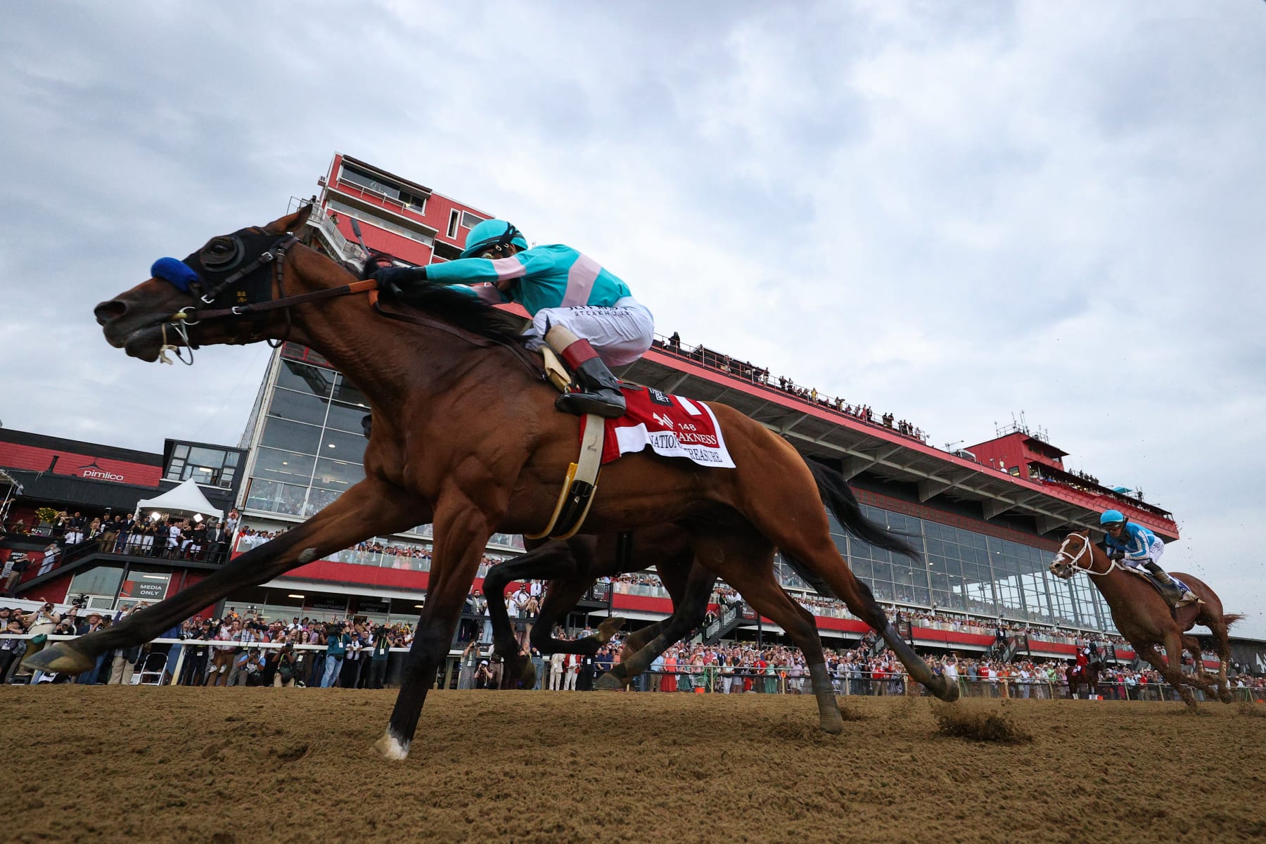 BALTIMORE, MARYLAND - MAY 20: Jockey John Velazquez #1 riding National Treasure crosses the finish line to win the 148th Running of the Preakness Stakes at Pimlico Race Course on May 20, 2023 in Baltimore, Maryland. (Photo by Patrick Smith/Getty Images)