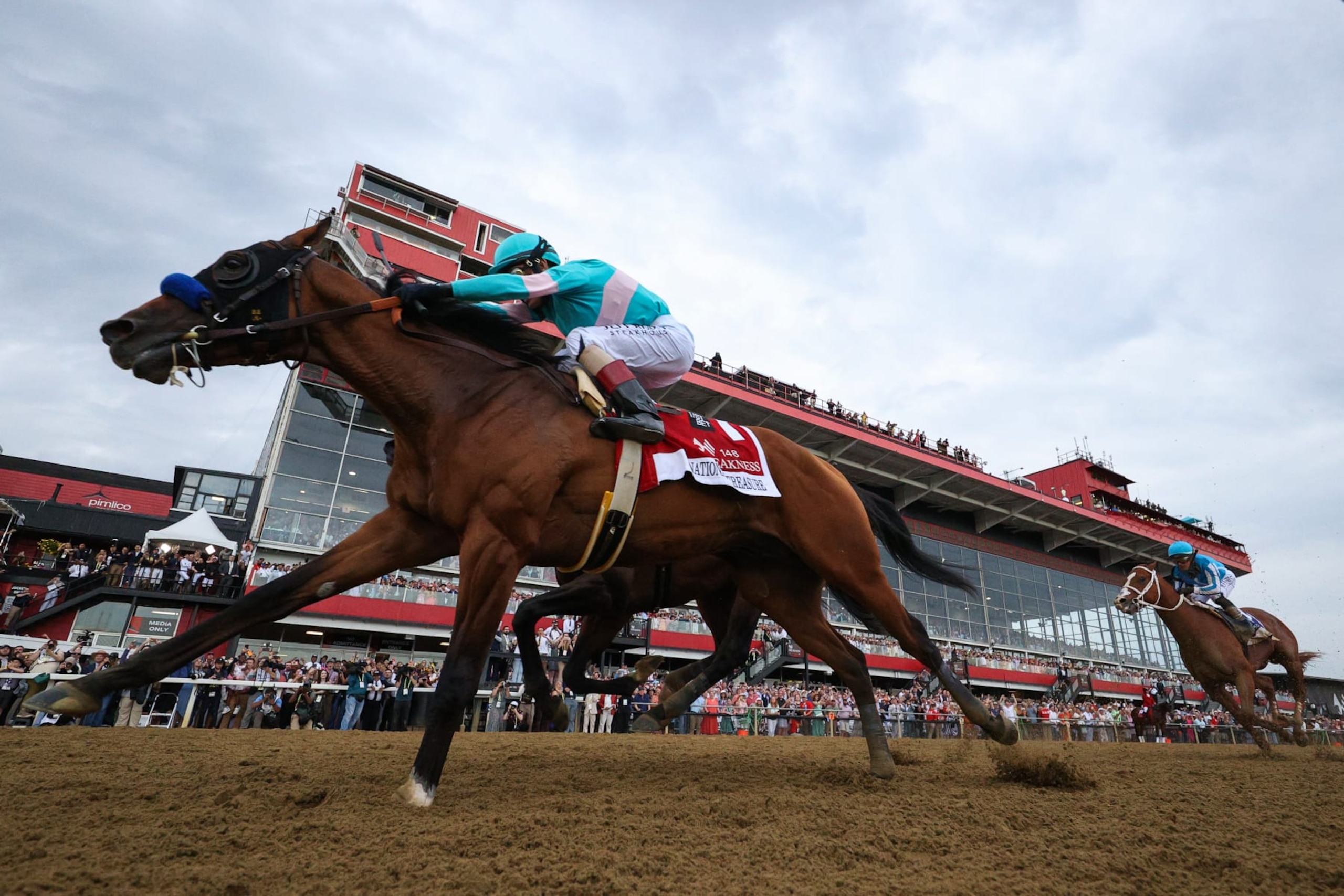BALTIMORE, MARYLAND - MAY 20: Jockey John Velazquez #1 riding National Treasure crosses the finish line to win the 148th Running of the Preakness Stakes at Pimlico Race Course on May 20, 2023 in Baltimore, Maryland. (Photo by Patrick Smith/Getty Images)