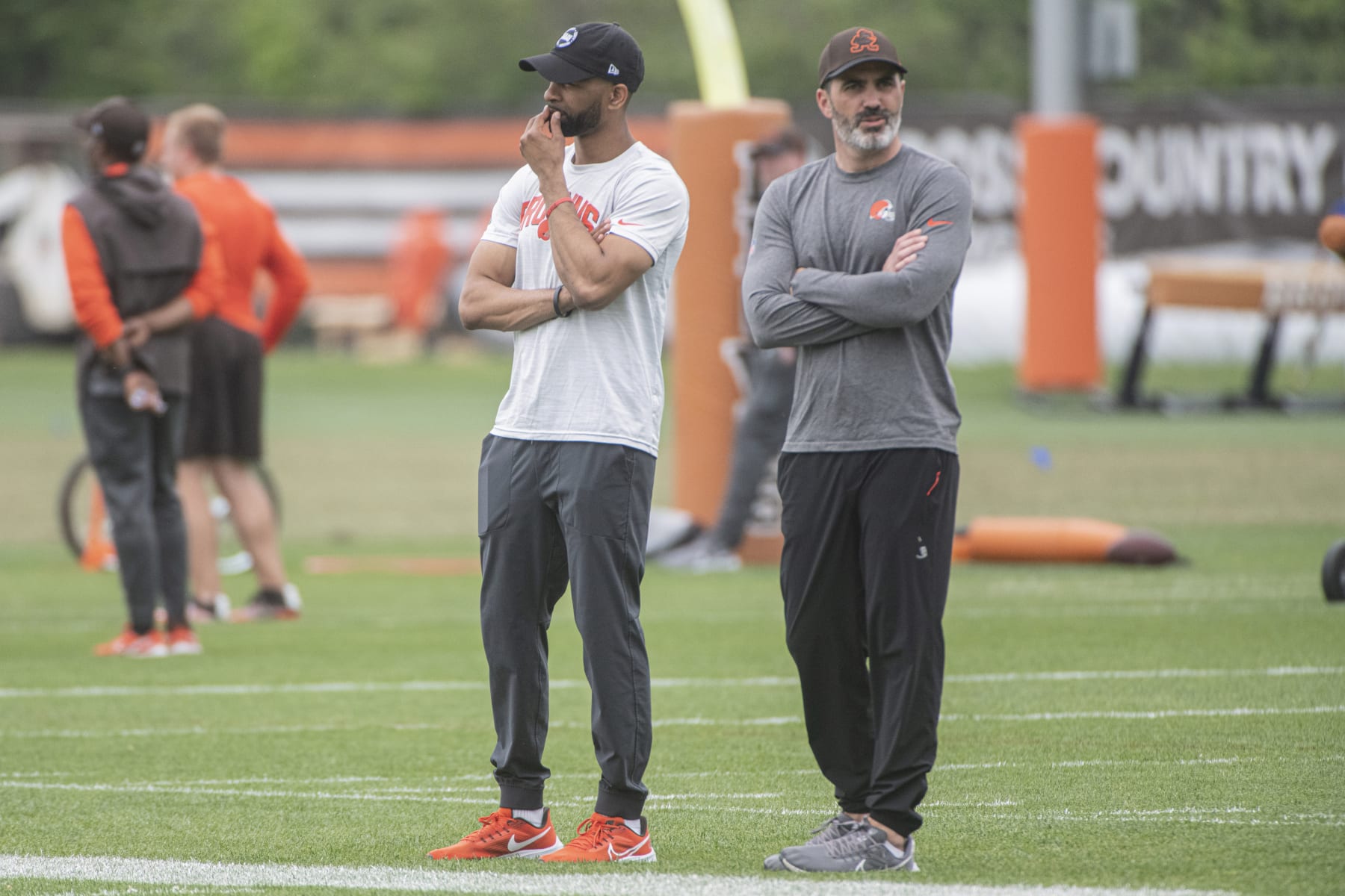 Cleveland Browns general manager Andrew Berry, left, and head coach Kevin Stefanski, right, watch the NFL football team's rookie minicamp in Berea, Ohio, Saturday, May 13, 2023. (AP Photo/Phil Long)