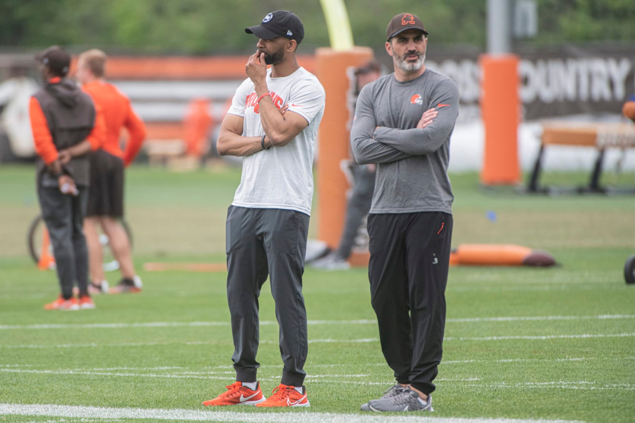 Cleveland Browns general manager Andrew Berry, left, and head coach Kevin Stefanski, right, watch the NFL football team's rookie minicamp in Berea, Ohio, Saturday, May 13, 2023. (AP Photo/Phil Long)