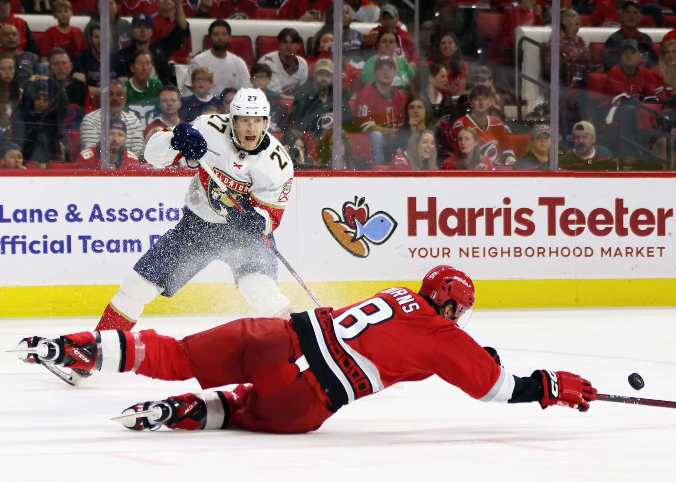 RALEIGH, NORTH CAROLINA - MAY 20: Eetu Luostarinen #27 of the Florida Panthers skates against Brent Burns #8 of the Carolina Hurricanes in Game Two of the Eastern Conference Finals of the 2023 Stanley Cup Playoffs at PNC Arena on May 20, 2023 in Raleigh, North Carolina. The Panthers defeated the Hurricanes 2-1 in overtime. (Photo by Bruce Bennett/Getty Images)
