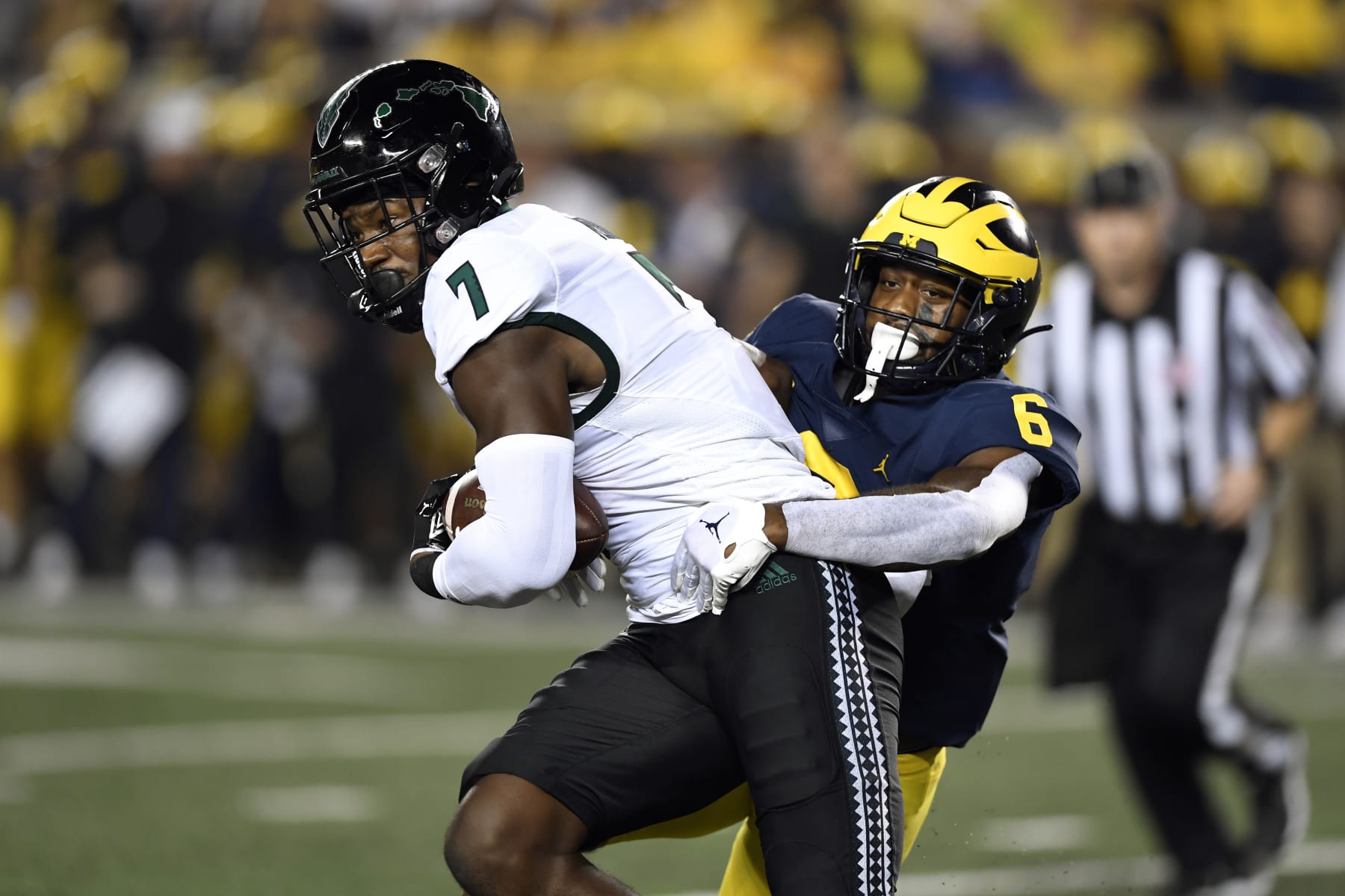 Hawaii tight end Jordan Murray, left, is tackled by Michigan defensive back R.J. Moten after a reception during the first half of an NCAA college football game Saturday, Sept. 10, 2022, in Ann Arbor, Mich. (AP Photo/Jose Juarez)
