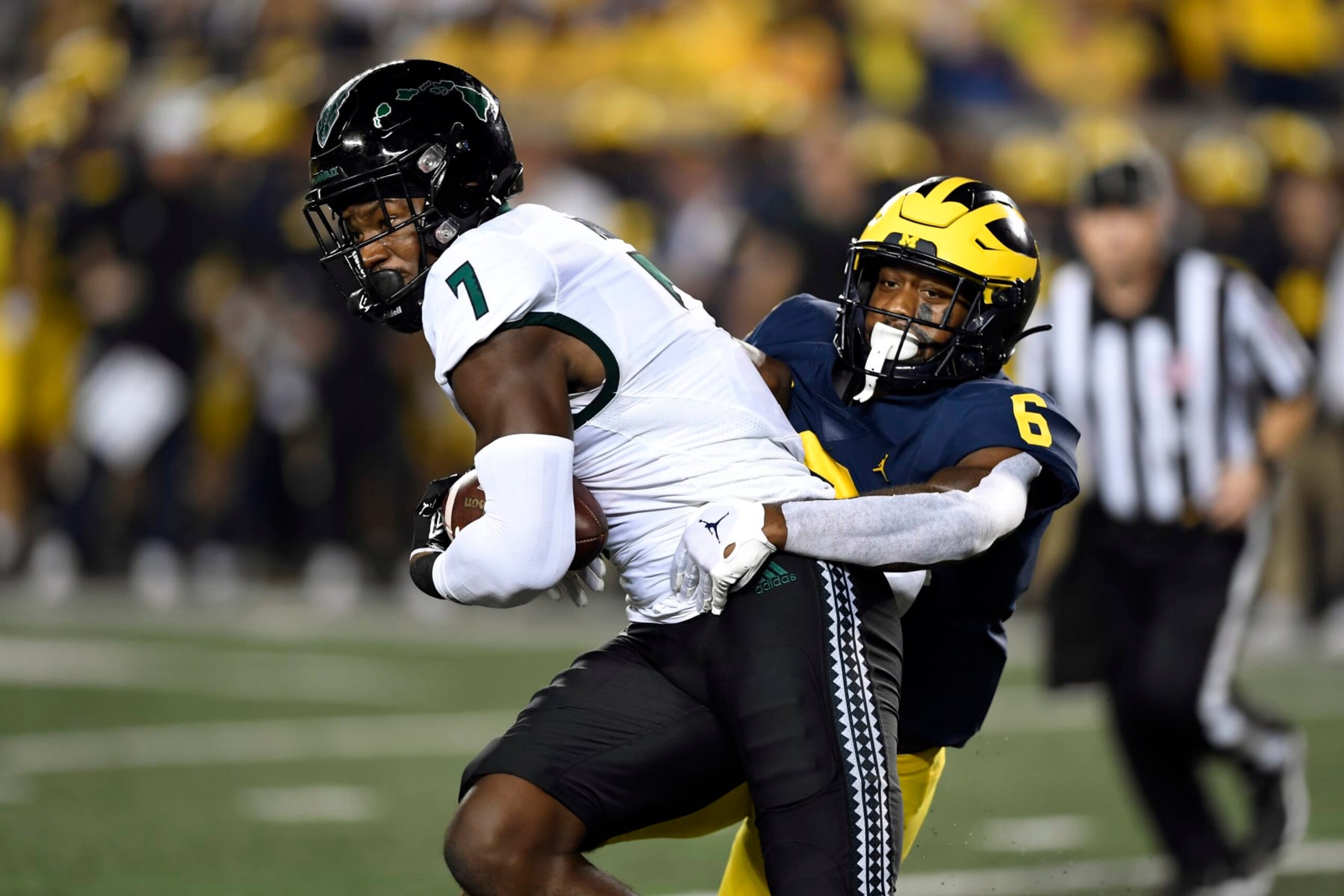 Hawaii tight end Jordan Murray, left, is tackled by Michigan defensive back R.J. Moten after a reception during the first half of an NCAA college football game Saturday, Sept. 10, 2022, in Ann Arbor, Mich. (AP Photo/Jose Juarez)