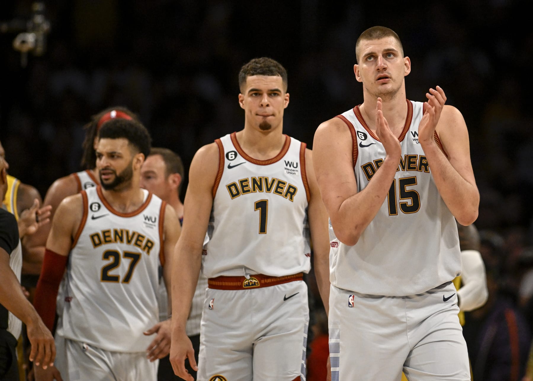 LOS ANGELES, CA - MAY 22: Nikola Jokic (15) of the Denver Nuggets claps as he is trailed by Jamal Murray (27) and Michael Porter Jr. (1) after teammate Aaron Gordon (50) engaged in an altercation with LeBron James (6) of the Los Angeles Lakers during the second quarter of the Western Conference finals game 4 at Crypto.com Arena in Los Angeles on Monday, May 22, 2023. (Photo by AAron Ontiveroz/The Denver Post)