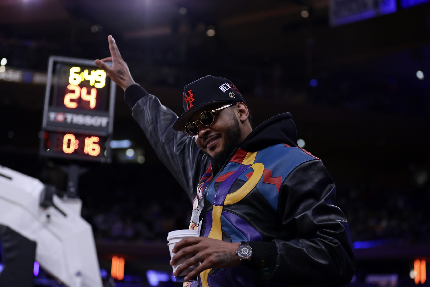 Former New York Knicks' Carmelo Anthony acknowledges the crowd during the first half of an NBA basketball game against the Philadelphia 76ers on Sunday, Dec. 25, 2022, in New York. (AP Photo/Adam Hunger)