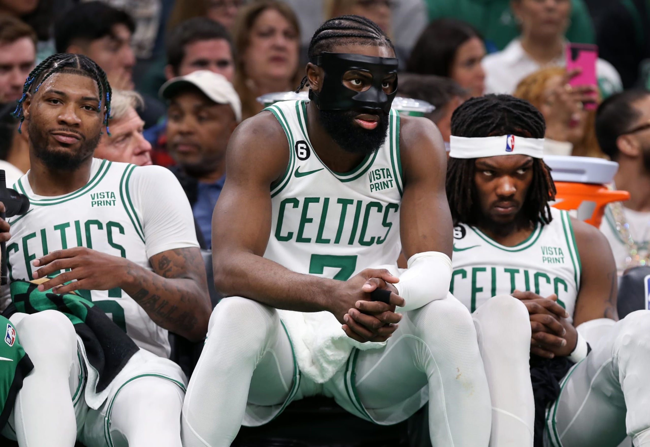 Boston, MA - May 17: From left, Boston Celtics Marcus Smart, Jaylen Brown and Robert Williams III watch the game from the bench in the third quarter. The Celtics lost to the Miami Heat, 123-116, in Game 1 of the 2023 Eastern Conference Finals. (Photo by Jim Davis/The Boston Globe via Getty Images)