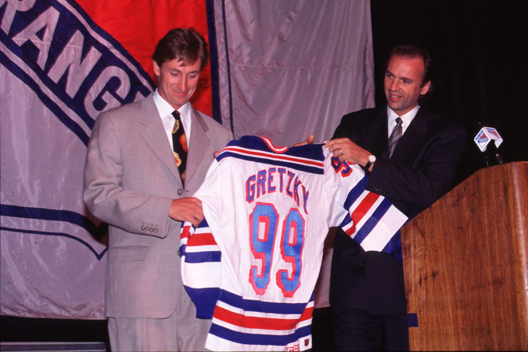1999 Season: Gretzky receives new Ranger jersey from Neil Smith And Player Wayne Gretzky.  (Photo by John Giamundo/Getty Images)