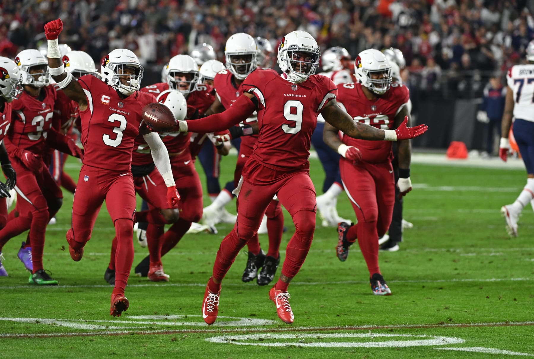 GLENDALE, ARIZONA - DECEMBER 12: Isaiah Simmons #9 of the Arizona Cardinals celebrates with teammates after intercepting a pass against the New England Patriots at State Farm Stadium on December 12, 2022 in Glendale, Arizona. (Photo by Norm Hall/Getty Images)