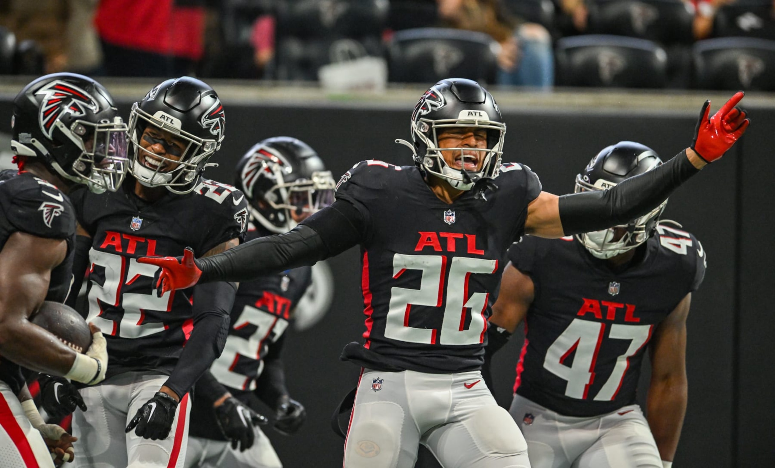 ATLANTA, GA  OCTOBER 30:  Atlanta cornerback Isaiah Oliver (26) celebrates the interception return by teammate Lorenzo Carter (9) during the NFL game between the Carolina Panthers and the Atlanta Falcons on October 30th, 2022 at Mercedes-Benz Stadium in Atlanta, GA.  (Photo by Rich von Biberstein/Icon Sportswire via Getty Images)