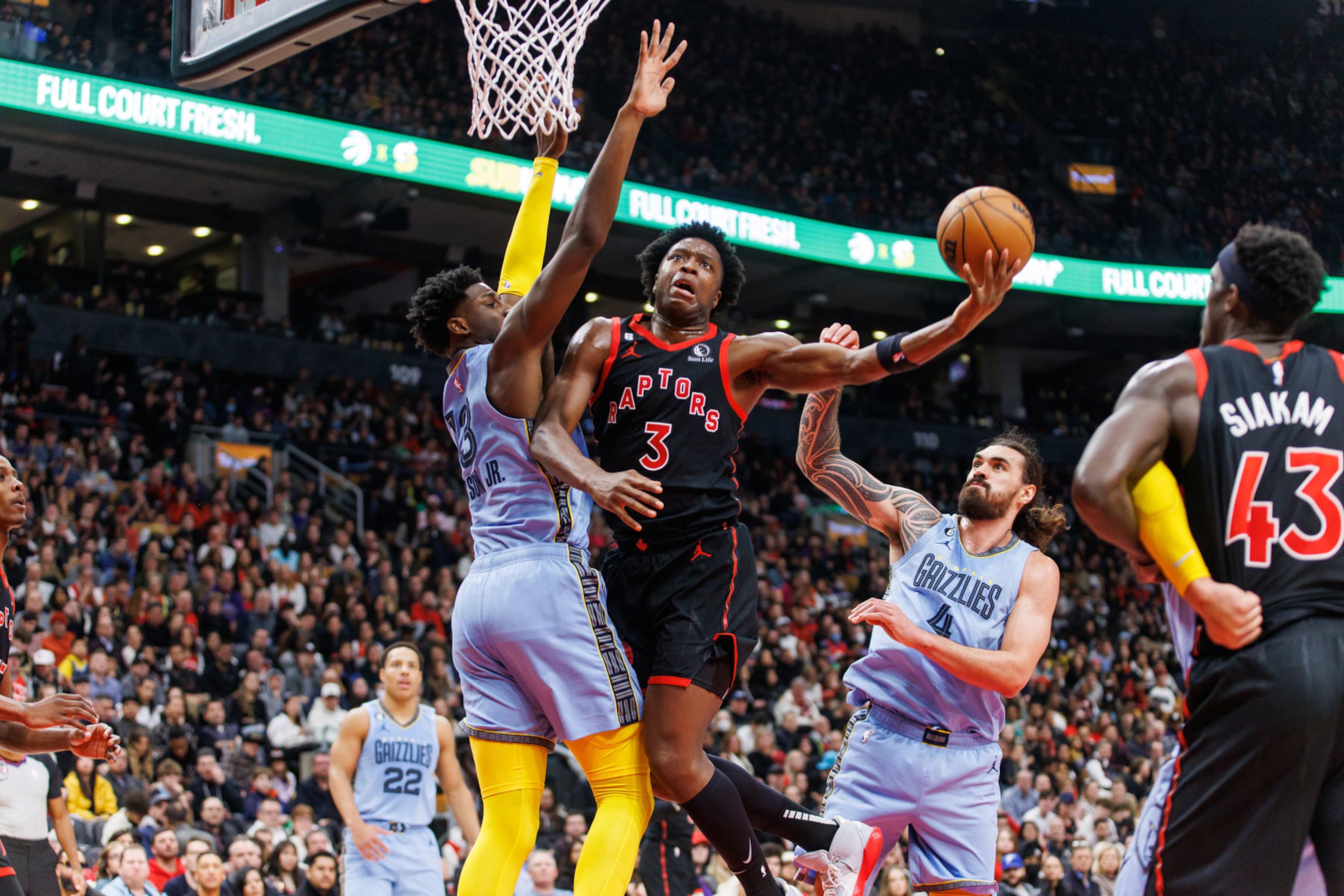 TORONTO, ON - DECEMBER 29: O.G. Anunoby #3 of the Toronto Raptors drives to the net against Jaren Jackson Jr. #13 of the Memphis Grizzlies during the first half of their NBA game at Scotiabank Arena on December 29, 2022 in Toronto, Canada. NOTE TO USER: User expressly acknowledges and agrees that, by downloading and or using this photograph, User is consenting to the terms and conditions of the Getty Images License Agreement. (Photo by Cole Burston/Getty Images)