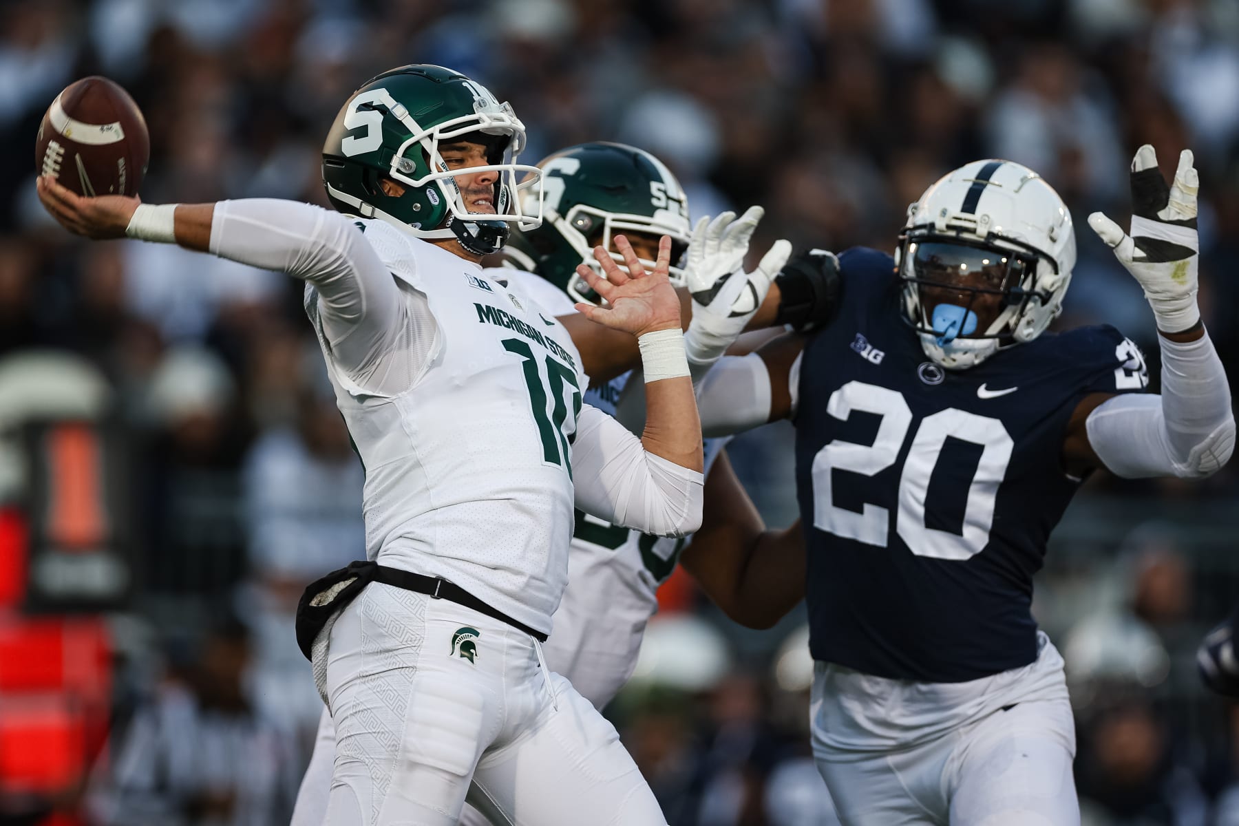 STATE COLLEGE, PA - NOVEMBER 26: Payton Thorne #10 of the Michigan State Spartans attempts a pass as Adisa Isaac #20 of the Penn State Nittany Lions applies pressure during the first half at Beaver Stadium on November 26, 2022 in State College, Pennsylvania. (Photo by Scott Taetsch/Getty Images)