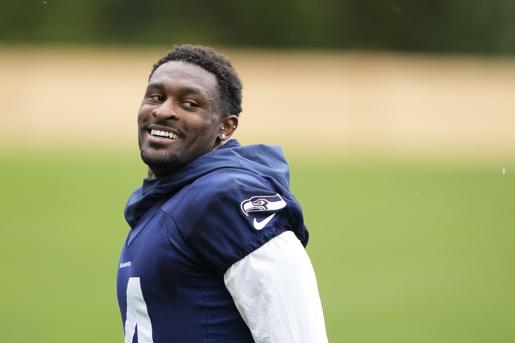 Seattle Seahawks wide receiver DK Metcalf smiles while jogging off the field after team activities Monday, May 22, 2023, at the team's NFL football training facility in Renton, Wash. (AP Photo/Lindsey Wasson)