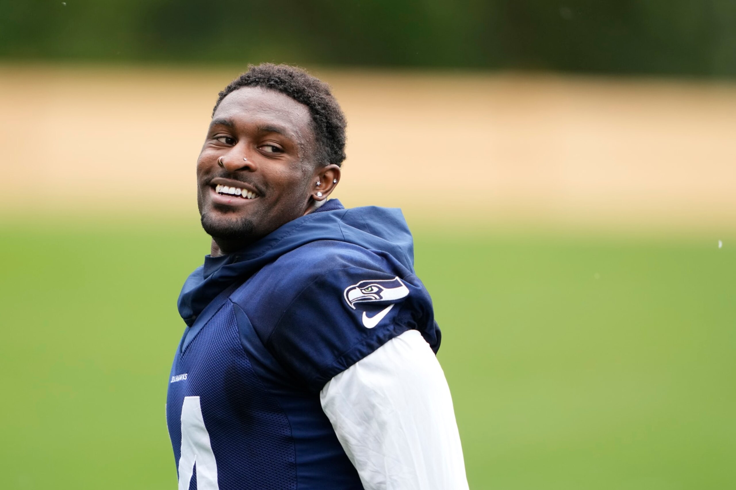 Seattle Seahawks wide receiver DK Metcalf smiles while jogging off the field after team activities Monday, May 22, 2023, at the team's NFL football training facility in Renton, Wash. (AP Photo/Lindsey Wasson)