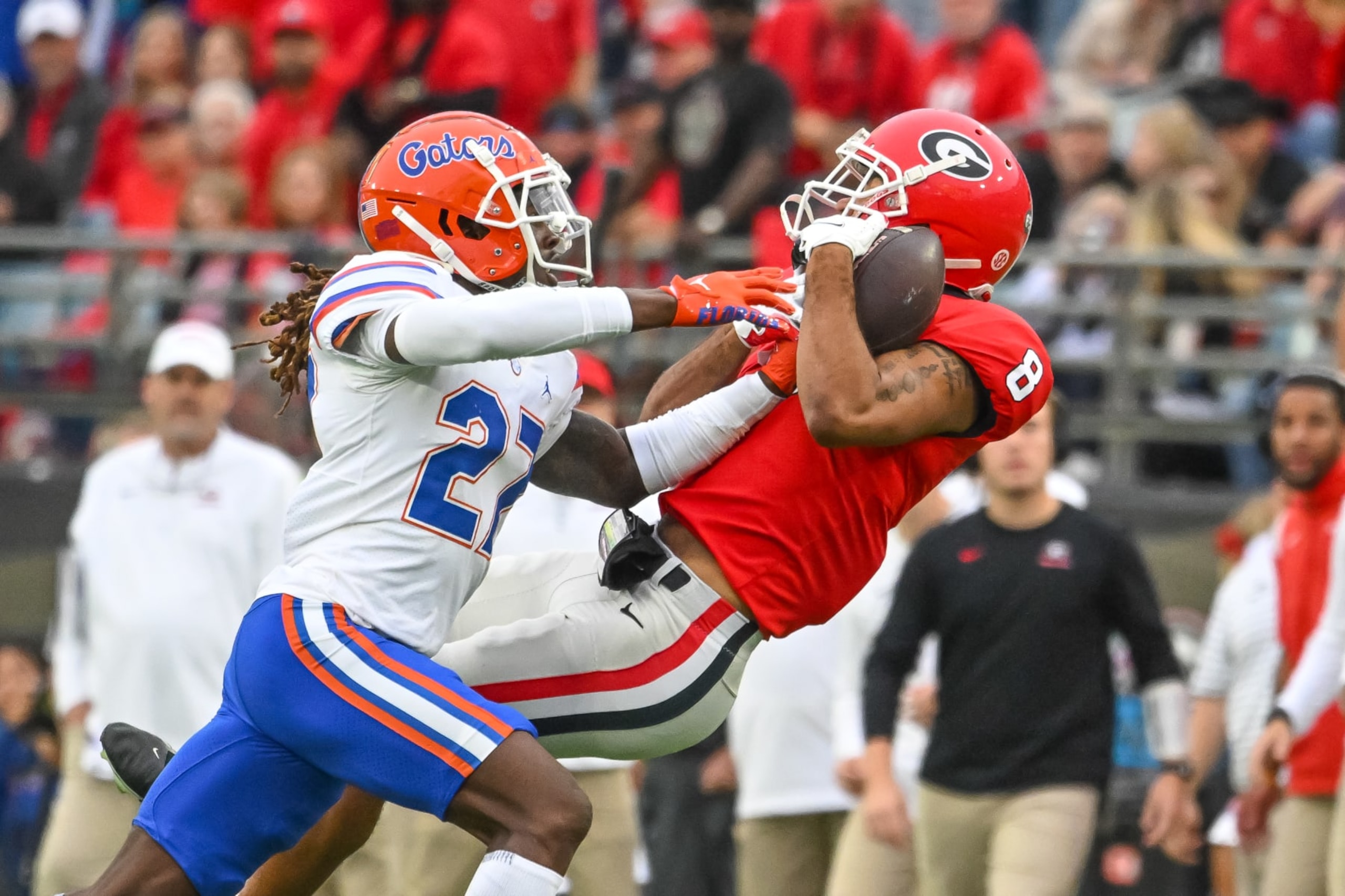 JACKSONVILLE, FL - OCTOBER 29: Florida Gators safety Jadarrius Perkins (27) takes the ball away from Georgia Bulldogs wide receiver Dominick Blaylock (8) as they fall to the ground for an interception during the college football game between the Florida Gators and Georgia Bulldogs on October 29, 2022, at TIAA Bank Field in Jacksonville, Florida. (Photo by John Adams/Icon Sportswire via Getty Images)