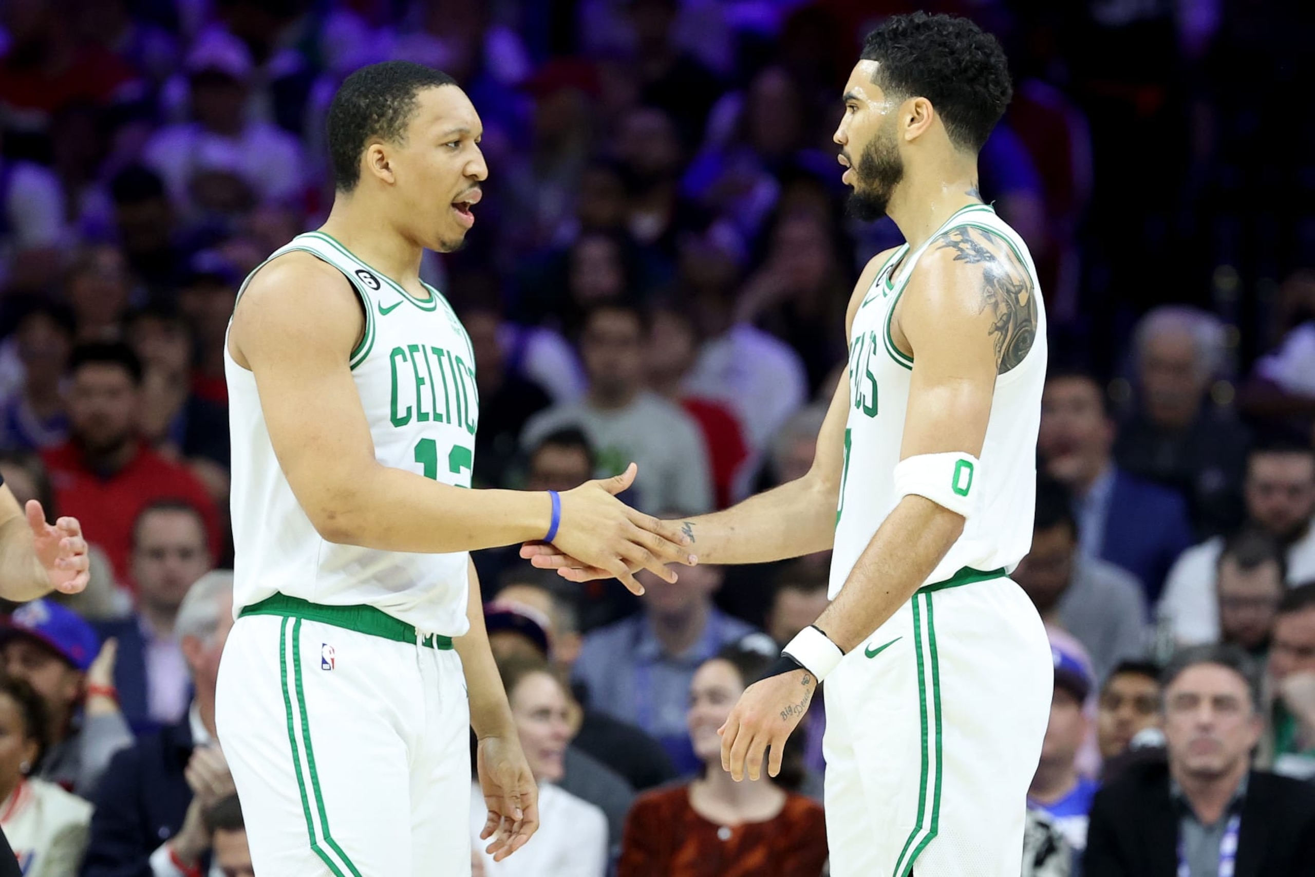 PHILADELPHIA, PENNSYLVANIA - MAY 07: Grant Williams #12 and Jayson Tatum #0 of the Boston Celtics high five against the Philadelphia 76ers during the first quarter in game four of the Eastern Conference Second Round Playoffs at Wells Fargo Center on May 07, 2023 in Philadelphia, Pennsylvania. NOTE TO USER: User expressly acknowledges and agrees that, by downloading and or using this photograph, User is consenting to the terms and conditions of the Getty Images License Agreement. (Photo by Tim Nwachukwu/Getty Images)