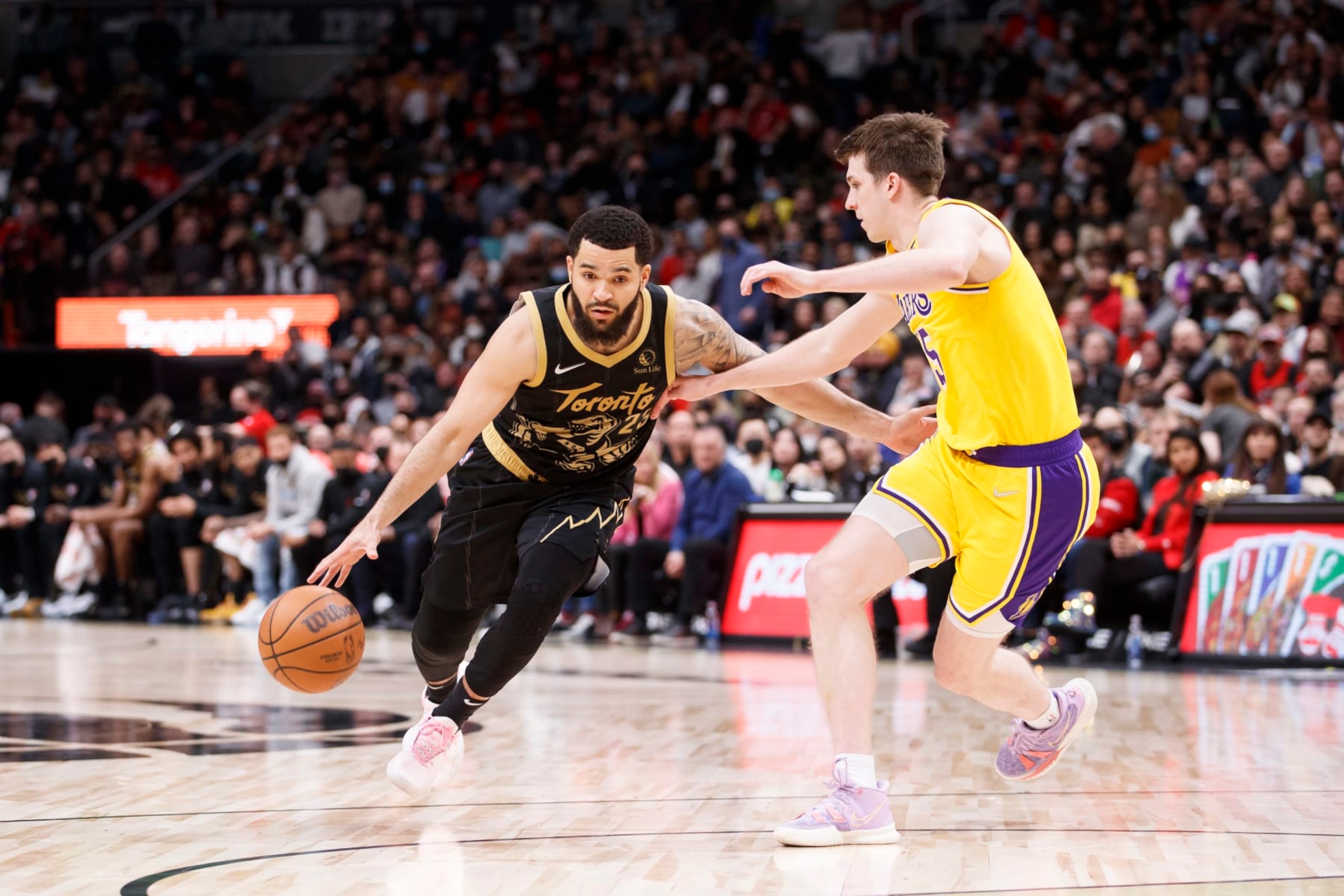 TORONTO, ON - MARCH 18: Fred VanVleet #23 of the Toronto Raptors dribbles against Austin Reaves #15 of the Los Angeles Lakers during the second half of their NBA game at Scotiabank Arena on March 18, 2022 in Toronto, Canada. NOTE TO USER: User expressly acknowledges and agrees that, by downloading and or using this Photograph, user is consenting to the terms and conditions of the Getty Images License Agreement. (Photo by Cole Burston/Getty Images)