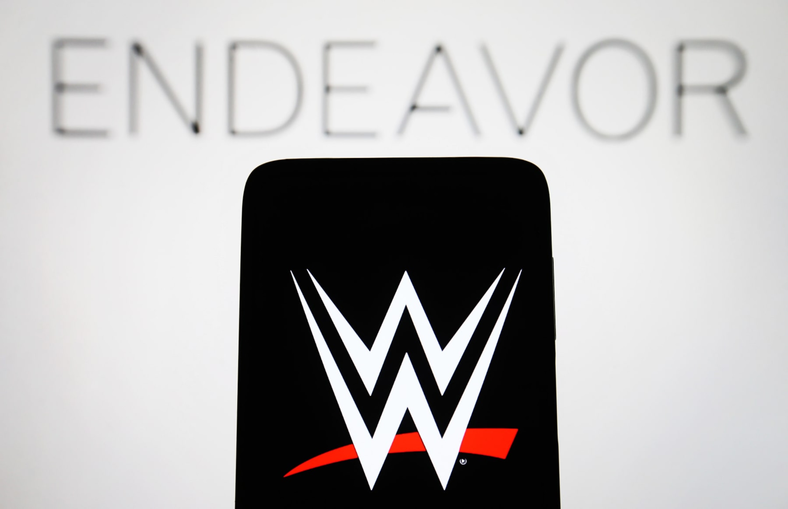 UKRAINE - 2023/04/03: In this photo illustration, a World Wrestling Entertainment, Inc. (WWE) logo is seen on a smartphone and Endeavor Group Holdings, Inc. logo on a pc screen. (Photo Illustration by Pavlo Gonchar/SOPA Images/LightRocket via Getty Images) UKRAINE - 2023/04/03: In this photo illustration, a World Wrestling Entertainment, Inc. (WWE) logo is seen on a smartphone and Endeavor Group Holdings, Inc. logo on a pc screen. (Photo Illustration by Pavlo Gonchar/SOPA Images/LightRocket via Getty Images)