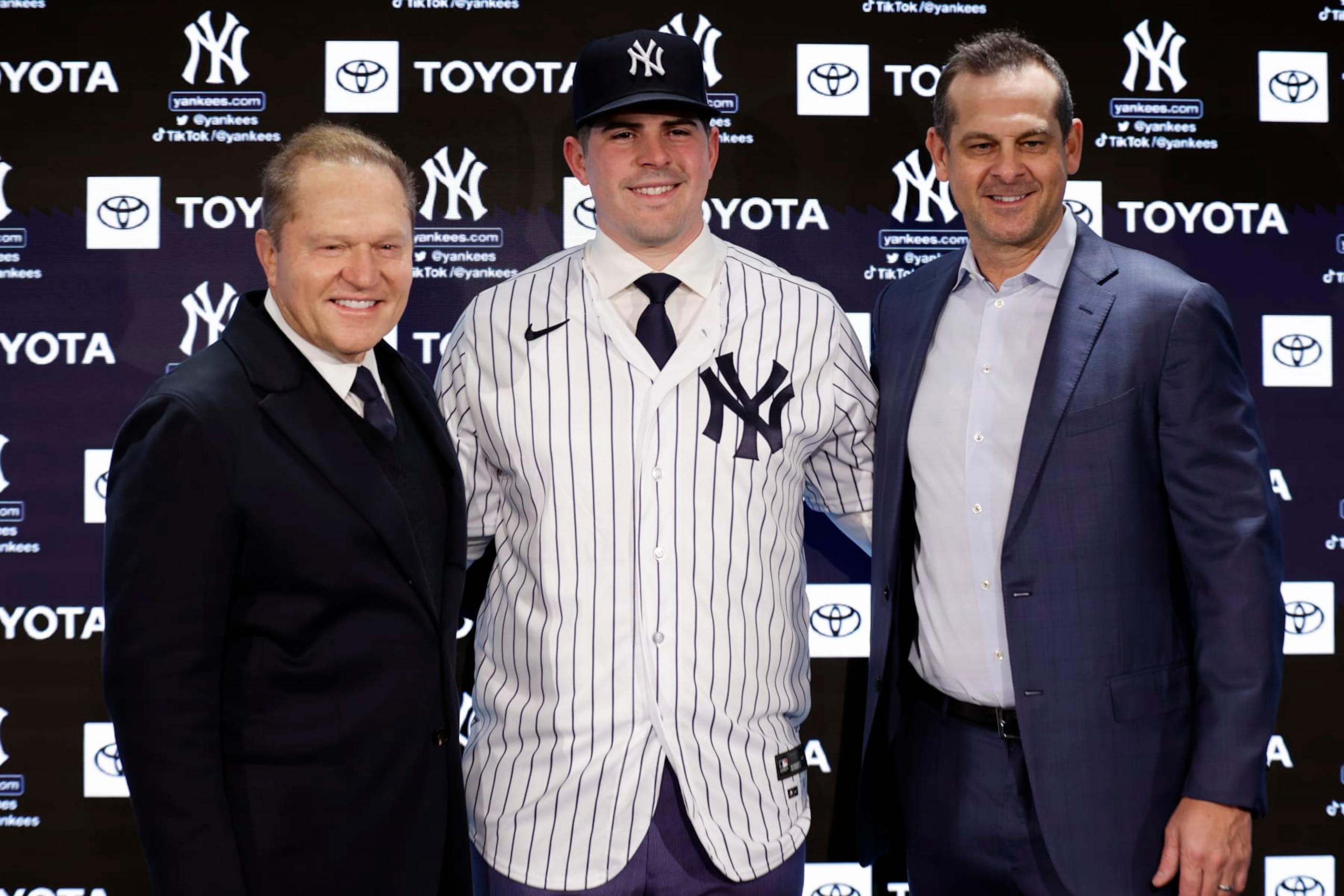 New York Yankees' Carlos Rodon, center, poses for a photo with his agent Scott Boras and manager Aaron Boone, right, during his introductory baseball news conference at Yankee Stadium, Thursday, Dec. 22, 2022, in New York. (AP Photo/Adam Hunger)