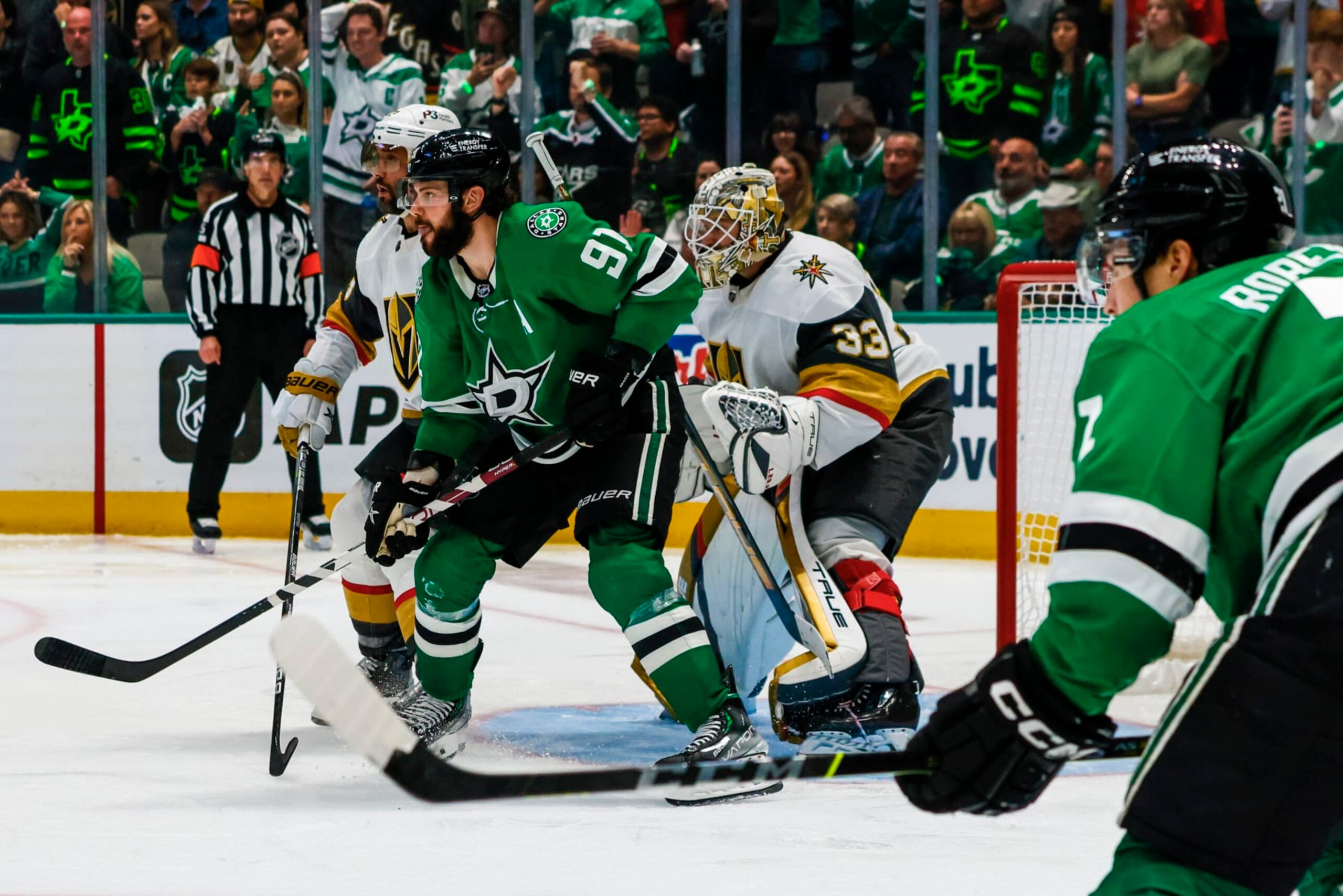 DALLAS, TX - MAY 25: Vegas Golden Knights defenseman Alec Martinez (23) and Dallas Stars center Tyler Seguin (91) set up in front of goaltender Adin Hill (33) during game 4 of the Western Conference Finals between the Dallas Stars and the Vegas Golden Knights on May 25, 2023 at the American Airlines Center in Dallas, Texas. (Photo by Matthew Pearce/Icon Sportswire via Getty Images)