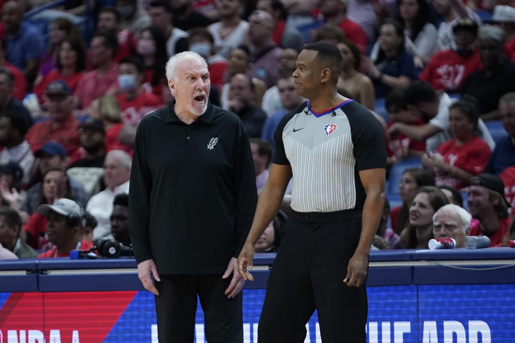 San Antonio Spurs head coach Gregg Popovich challenges a referee in the first half of an NBA play-in basketball game in New Orleans, Wednesday, April 13, 2022. (AP Photo/Gerald Herbert)