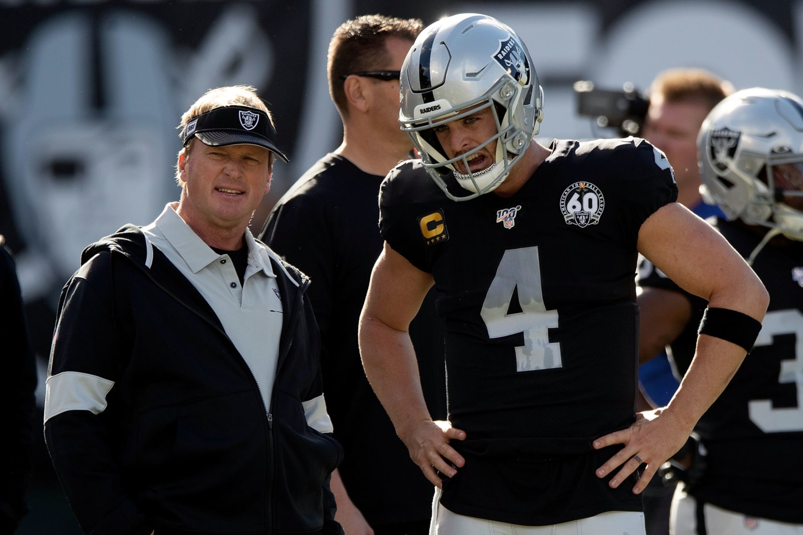 OAKLAND, CA - DECEMBER 15: Head coach Jon Gruden of the Oakland Raiders talks to quarterback Derek Carr #4 before the game against the Jacksonville Jaguars at RingCentral Coliseum on December 15, 2019 in Oakland, California.  (Photo by Jason O. Watson/Getty Images)