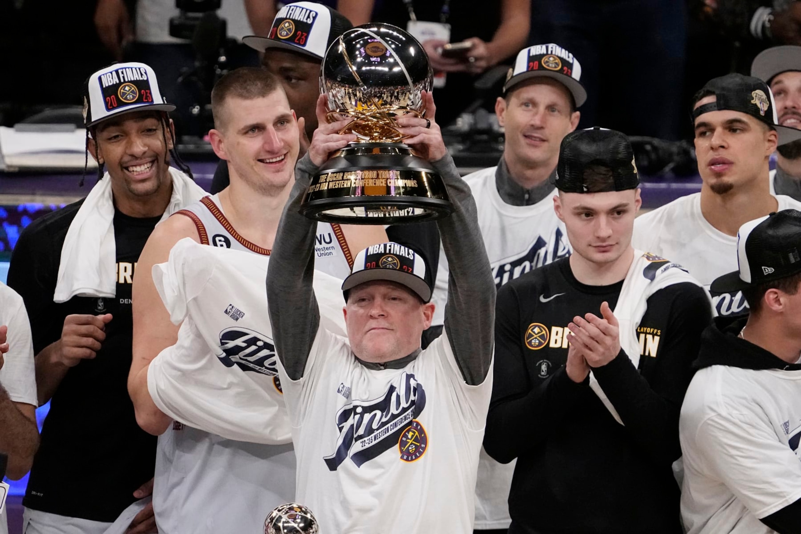 Denver Nuggets head coach Michael Malone lift the conference championship trophy after defeating the Los Angeles Lakers 113-111 in Game 4 of the NBA basketball Western Conference Final series Monday, May 22, 2023, in Los Angeles. (AP Photo/Mark J. Terrill) Denver Nuggets head coach Michael Malone lift the conference championship trophy after defeating the Los Angeles Lakers 113-111 in Game 4 of the NBA basketball Western Conference Final series Monday, May 22, 2023, in Los Angeles. (AP Photo/Mark J. Terrill)