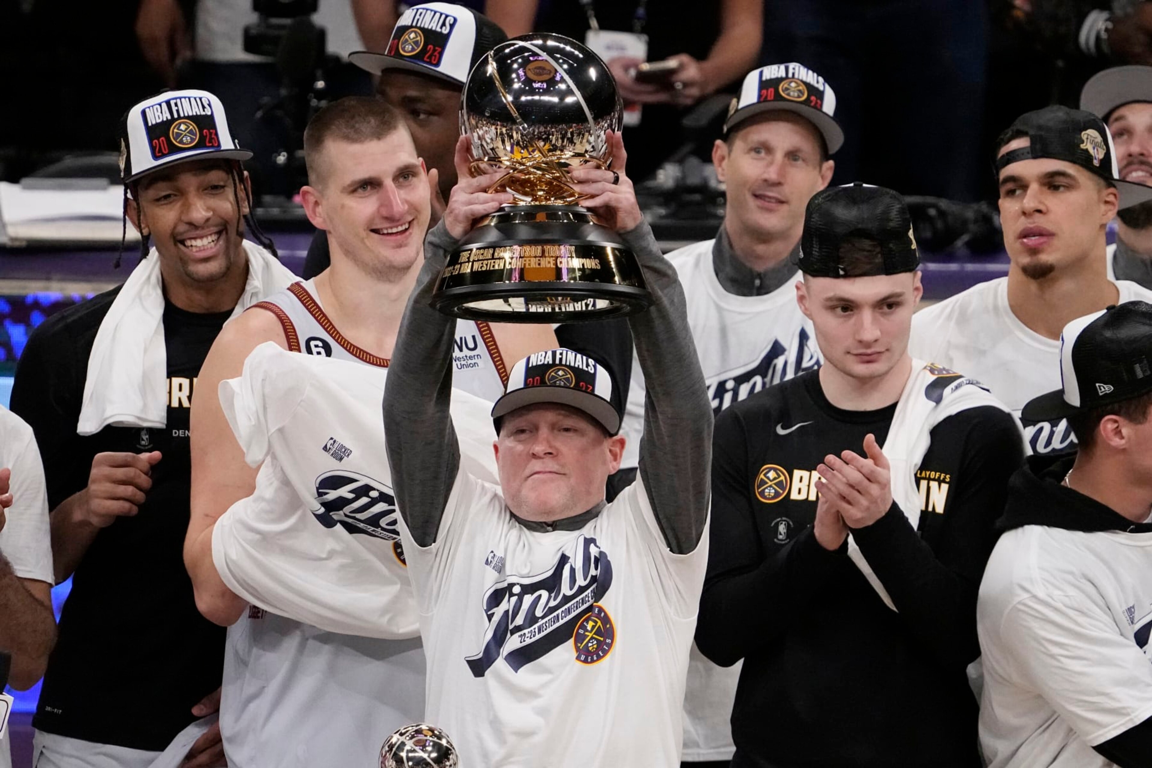 Denver Nuggets head coach Michael Malone lift the conference championship trophy after defeating the Los Angeles Lakers 113-111 in Game 4 of the NBA basketball Western Conference Final series Monday, May 22, 2023, in Los Angeles. (AP Photo/Mark J. Terrill) Denver Nuggets head coach Michael Malone lift the conference championship trophy after defeating the Los Angeles Lakers 113-111 in Game 4 of the NBA basketball Western Conference Final series Monday, May 22, 2023, in Los Angeles. (AP Photo/Mark J. Terrill)