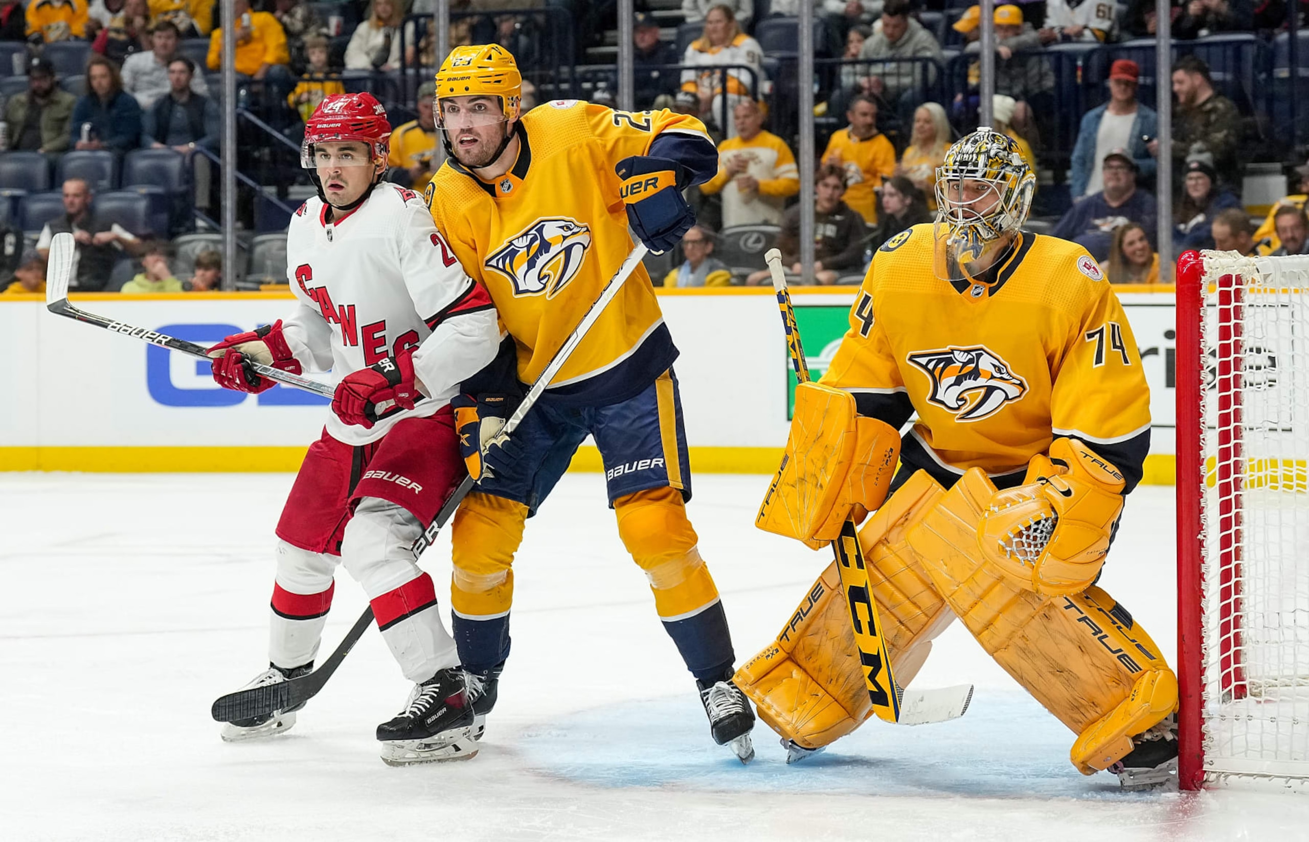 NASHVILLE, TENNESSEE - APRIL 6: Seth Jarvis #24 of the Carolina Hurricanes battles in front of the net against Jake Livingstone #23 and Juuse Saros #74 of the Nashville Predators during an NHL game at Bridgestone Arena on April 6, 2023 in Nashville, Tennessee. (Photo by John Russell/NHLI via Getty Images) NASHVILLE, TENNESSEE - APRIL 6: Seth Jarvis #24 of the Carolina Hurricanes battles in front of the net against Jake Livingstone #23 and Juuse Saros #74 of the Nashville Predators during an NHL game at Bridgestone Arena on April 6, 2023 in Nashville, Tennessee. (Photo by John Russell/NHLI via Getty Images)