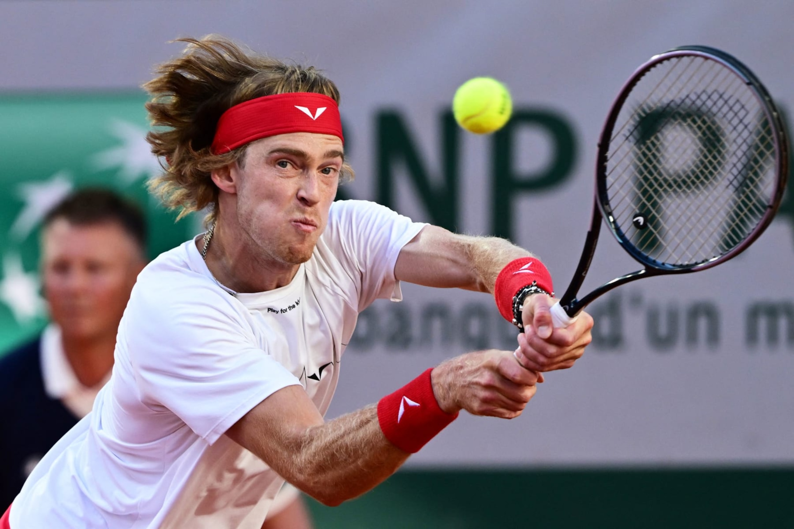 Russia's Andrey Rublev plays a backhand return to Serbia's Laslo Djere during their men's singles match on day one of the Roland-Garros Open tennis tournament at the Court Suzanne-Lenglen in Paris on May 28, 2023. (Photo by Emmanuel DUNAND / AFP) (Photo by EMMANUEL DUNAND/AFP via Getty Images)