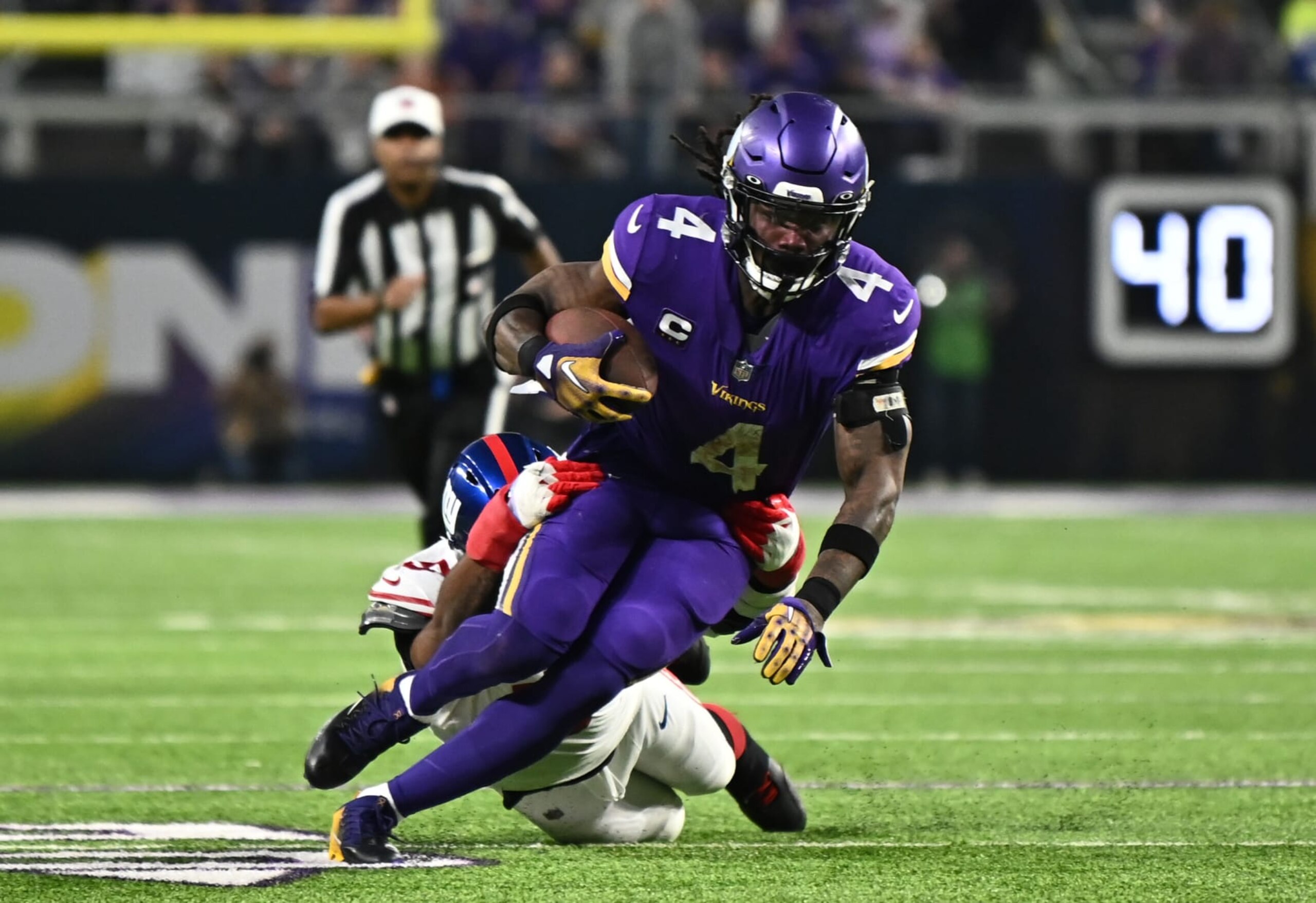 MINNEAPOLIS, MINNESOTA - JANUARY 15: Dalvin Cook #4 of the Minnesota Vikings rushes during the first half against the New York Giants in the NFC Wild Card playoff game at U.S. Bank Stadium on January 15, 2023 in Minneapolis, Minnesota. (Photo by Stephen Maturen/Getty Images)