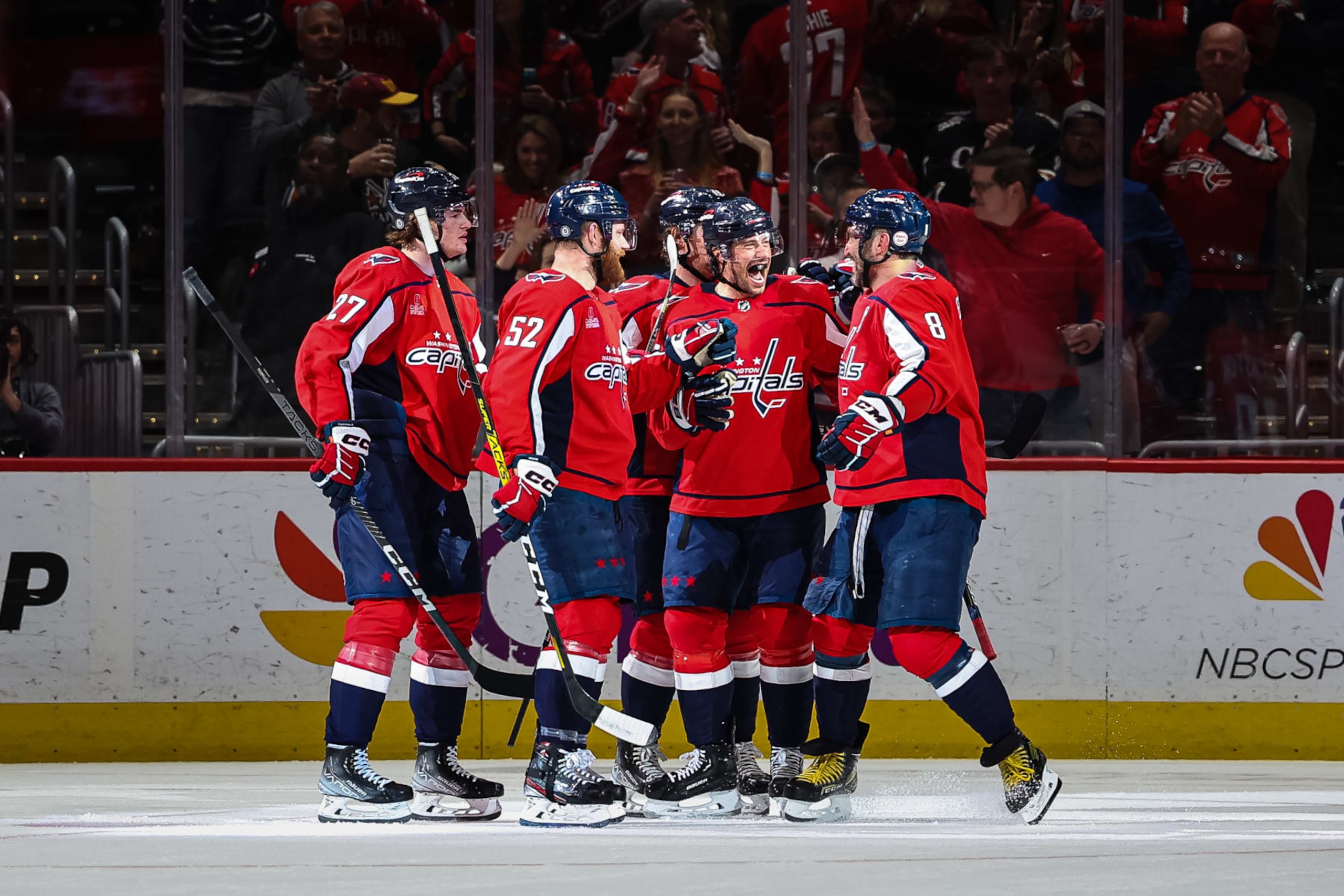 WASHINGTON, DC - APRIL 13: Craig Smith #16 of the Washington Capitals celebrates with Alex Ovechkin #8 and teammates after scoring a goal to record his 200th career NHL goal during the first period of the game against the New Jersey Devils at Capital One Arena on April 13, 2023 in Washington, DC. (Photo by Scott Taetsch/Getty Images)