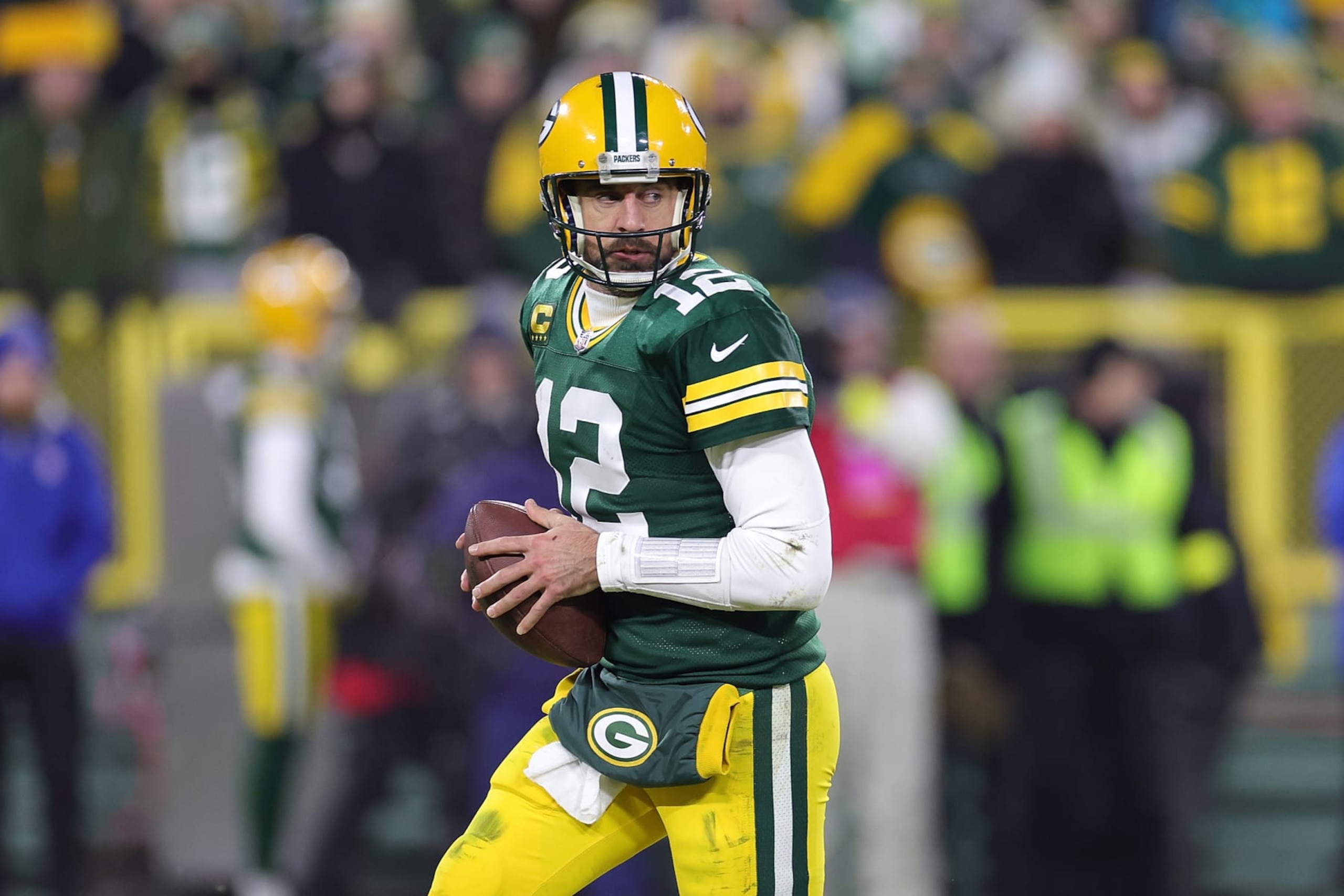 GREEN BAY, WISCONSIN - JANUARY 08: Aaron Rodgers #12 of the Green Bay Packers drops back to pass during a game against the Detroit Lions at Lambeau Field on January 08, 2023 in Green Bay, Wisconsin. The Lions defeated the Packers 20-16. (Photo by Stacy Revere/Getty Images)