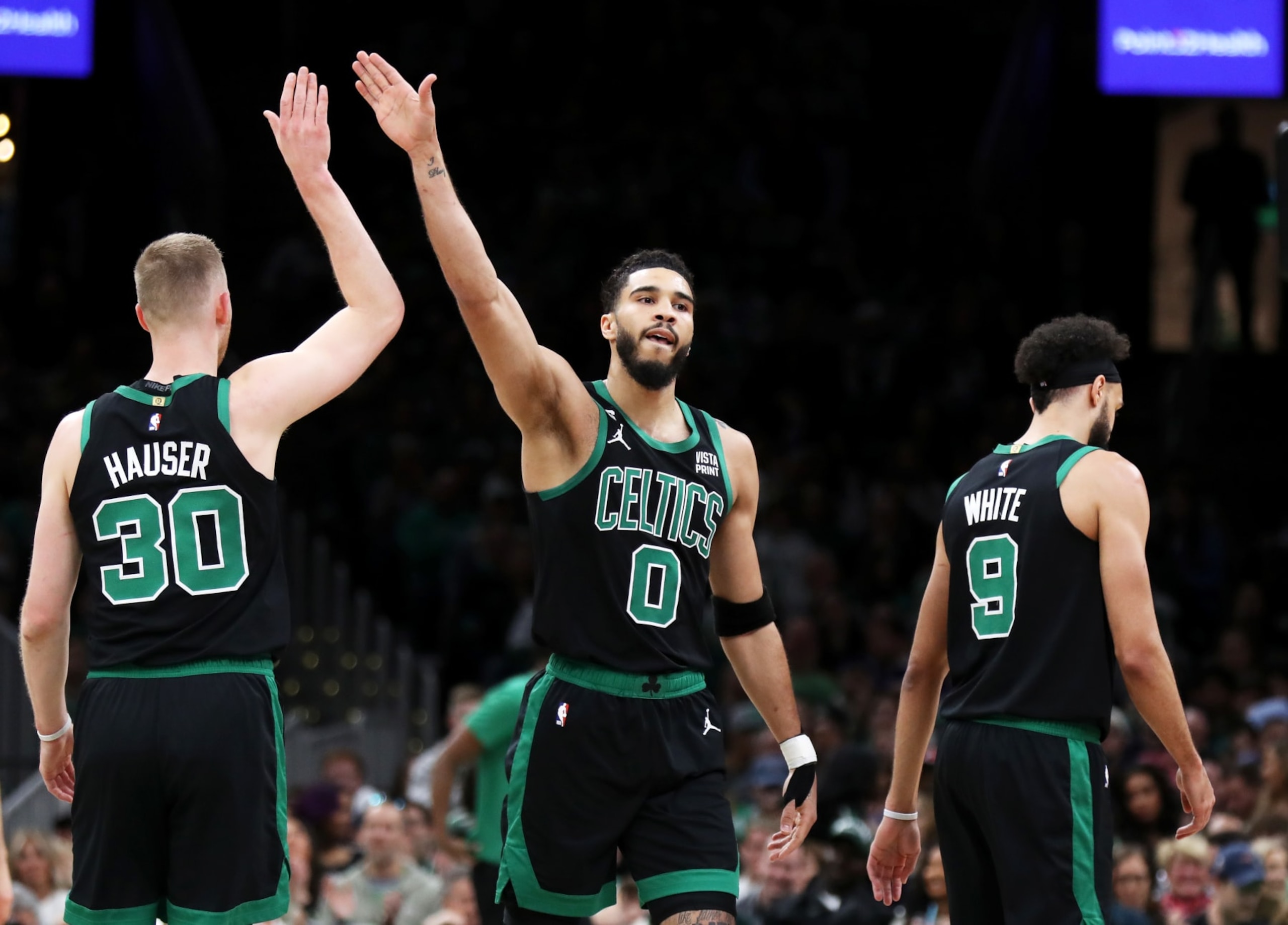 BOSTON, MASSACHUSETTS - APRIL 07: Jayson Tatum #0 and Sam Hauser #30 of the Boston Celtics high five during the first quarter of the game against the Toronto Raptors at TD Garden on April 07, 2023 in Boston, Massachusetts. NOTE TO USER: User expressly acknowledges and agrees that, by downloading and or using this photograph, User is consenting to the terms and conditions of the Getty Images License Agreement. (Photo by Omar Rawlings/Getty Images)